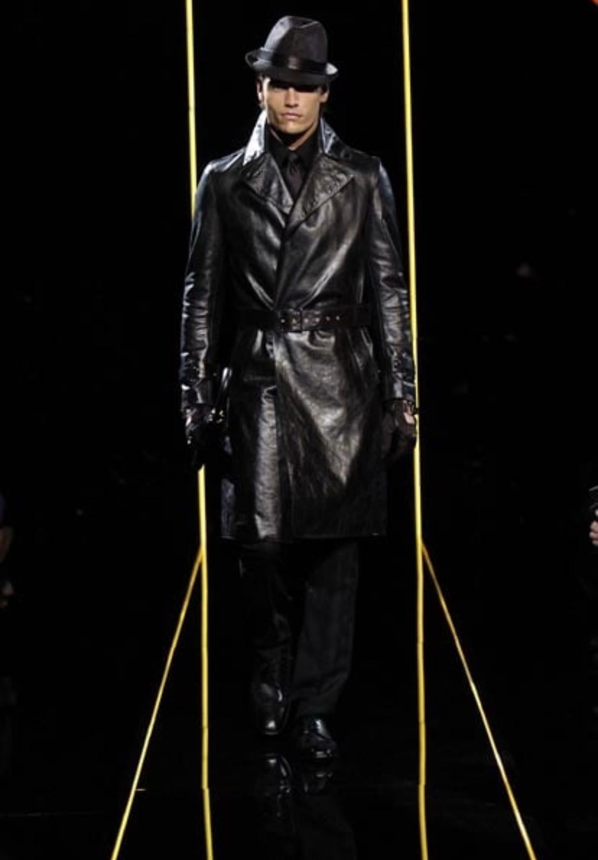 Designed by Donatella Versace for Versace's Fall/Winter 2005 men's collection, this coat debuted on the season's men's runway as part of look 5, modeled by Tyson Ballou. Constructed entirely of black leather, this sharp coat features a wide lapel,