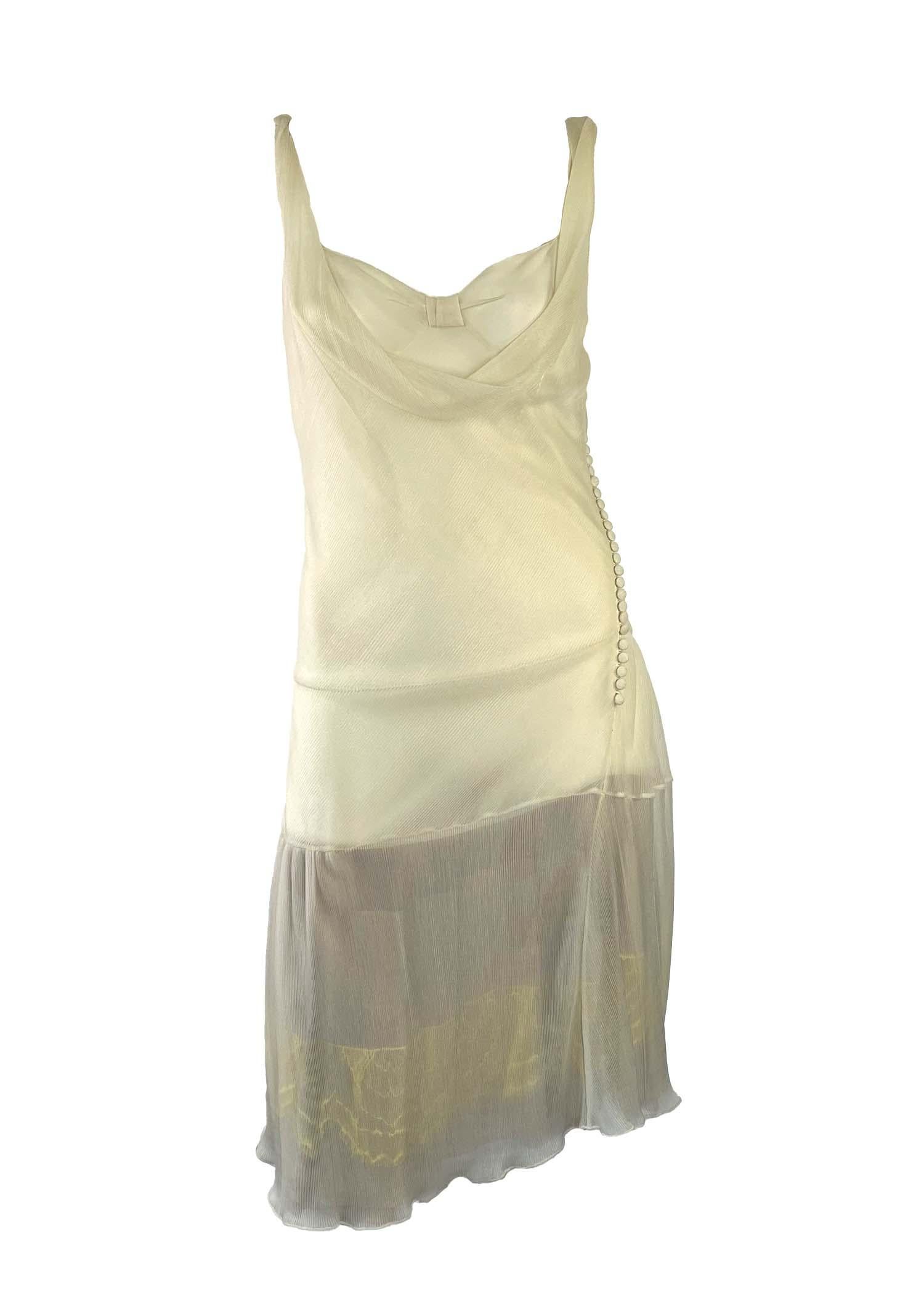 This stunning silk chiffon dress was designed by John Galliano for Dior's Fall/Winter 2006 collection. Constructed with ample amounts of sheer fabric, this piece is a true embodiment of Y2K style. The dress features ruffles, a contrasting yellow