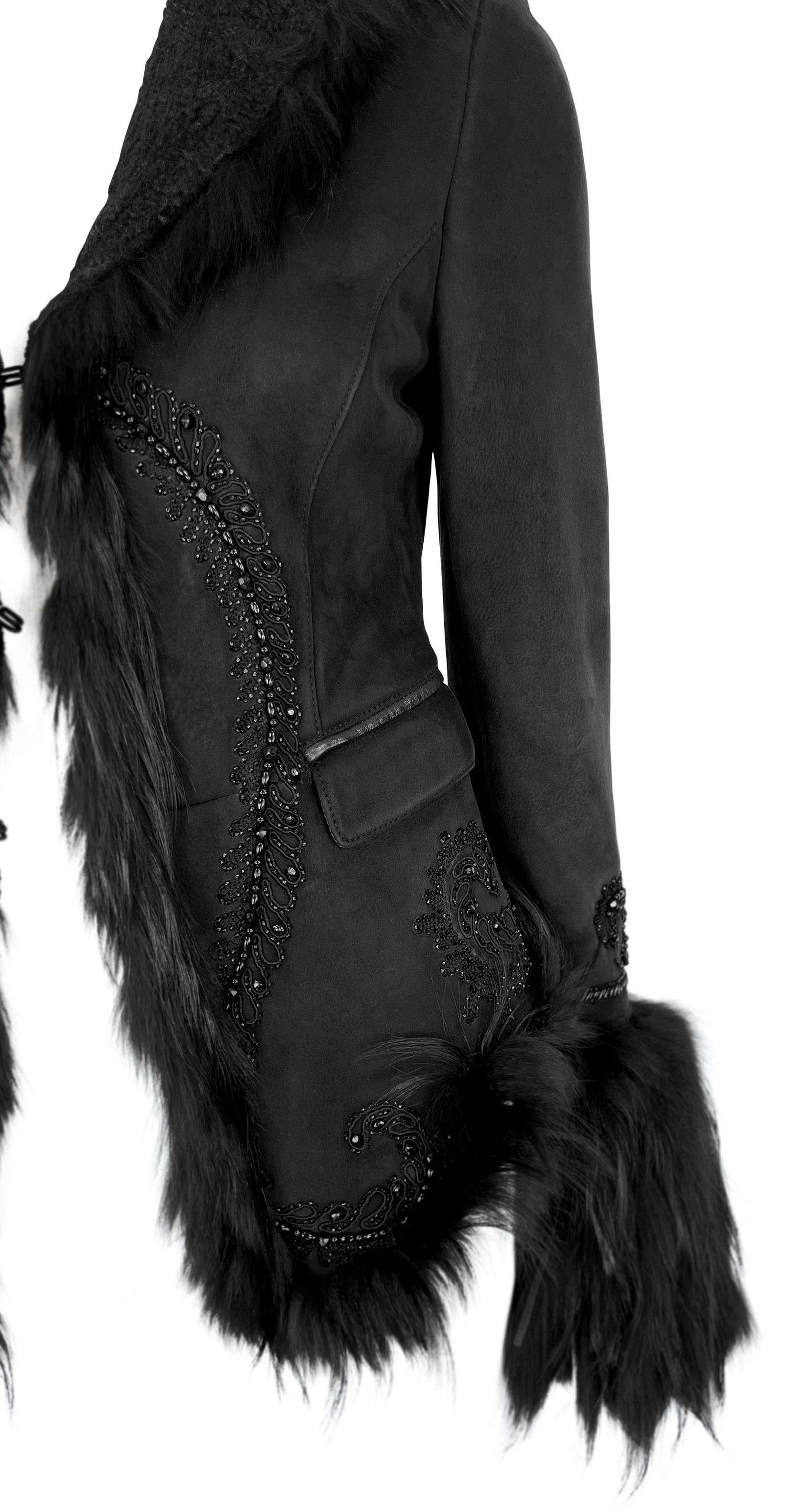This black suede shearling jacket from Roberto Cavalli’s Fall/Winter 2007 collection features a fitted silhouette trimmed with plush black fur along the collar, cuffs, and hem. Ornate beaded scrollwork enhances the front, nape, and sleeves, adding