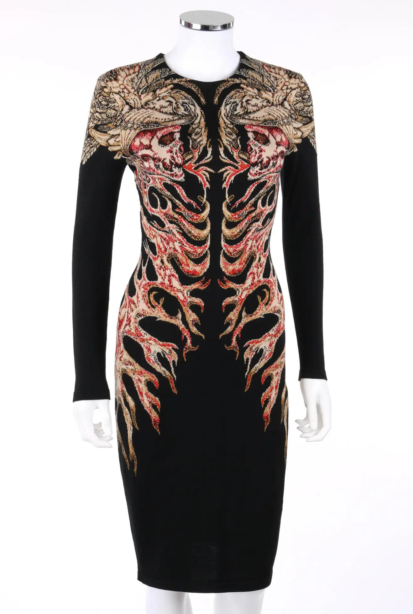 Alexander McQueen, F/W 2010 
Knit dress.
Wool and silk blend.

Multi-color angel wing skulls and flame pattern wraps around to back from center front. 
Long sleeves. 
Scoop neckline. 
Sheath pull on style. 
Measurements:
Shoulder: 15