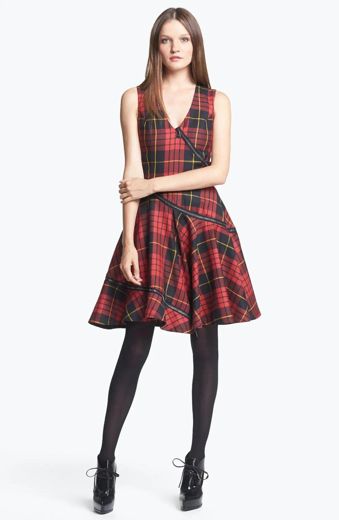 Alexander McQueen MCQ Red Tartan Wool Dress.
Classic tartan check, the zipper moves in a circle from the bodice to the hem. 
V-neck, sleeveless.
Concealed zipper at the back.
Size: US - 4, IT 40
Made in Portugal 
Excellent condition
