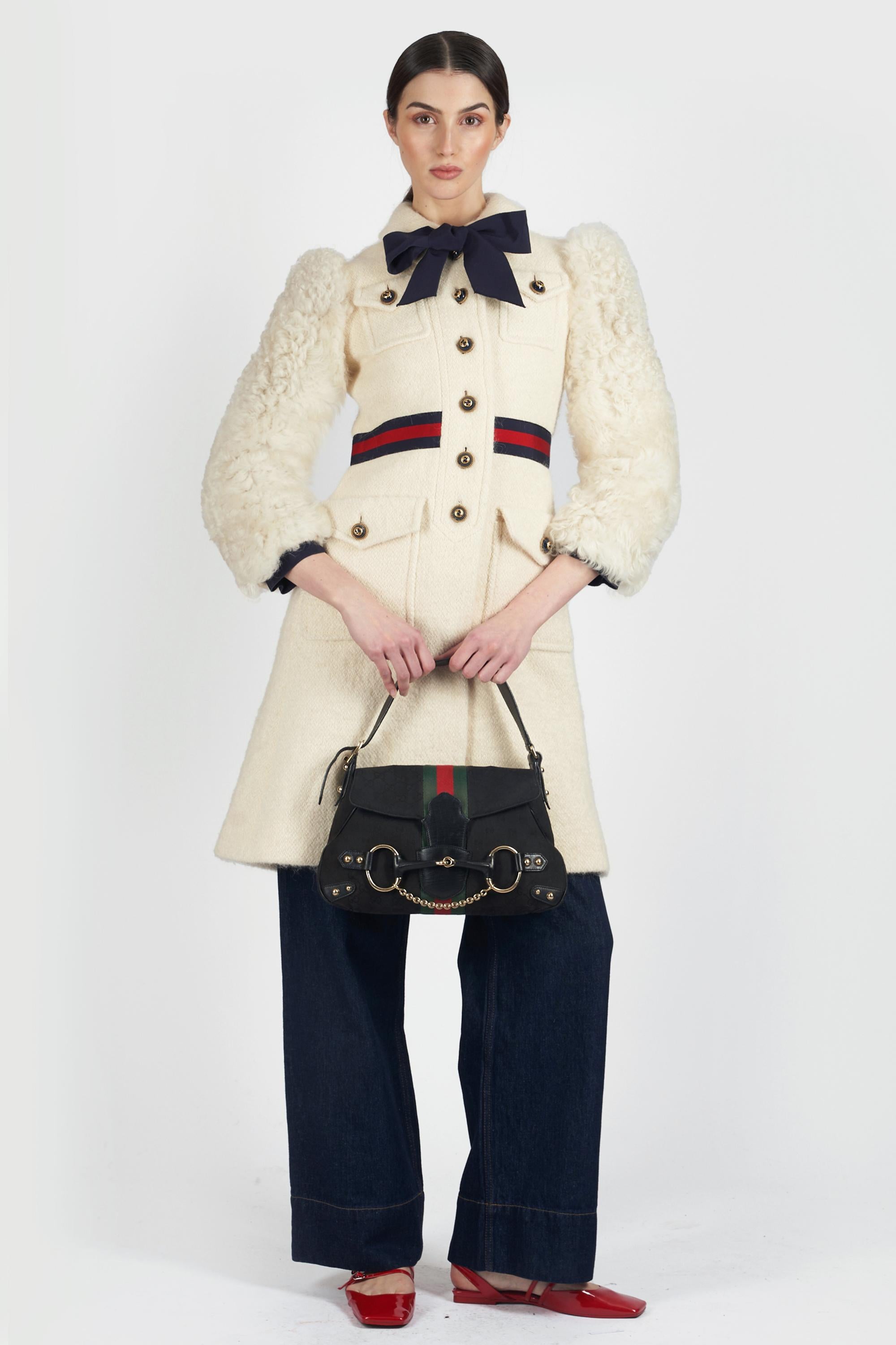 Gucci Fall Winter 2021 white coat. Features flap pockets, branded button closure, green and red belt detail and black ribbon on the collar with tags. In excellent vintage condition.
Brand: Gucci
Size: UK 4
Color: White
Label size: 36 IT
Modern size: