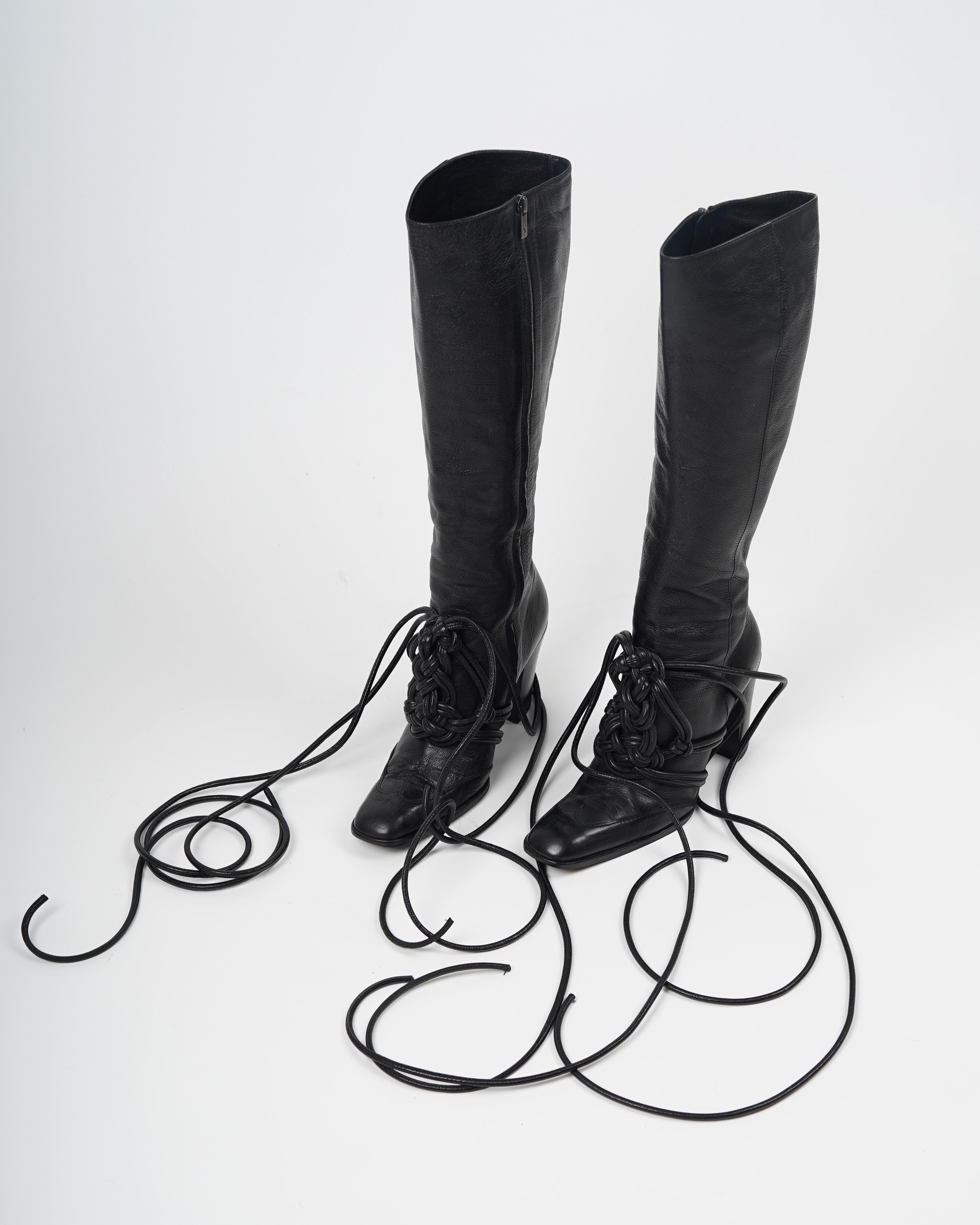 Presenting a pair of F/W 2001 Yves Saint Laurent by Tom Ford Black Leather, Lace-Up Runway & Campaign Boots in EU Size 39. 

- high-rise shaft
- black leather upper
- black leather lining
- square-toed
- side zips with logo-embossed, silver-toned