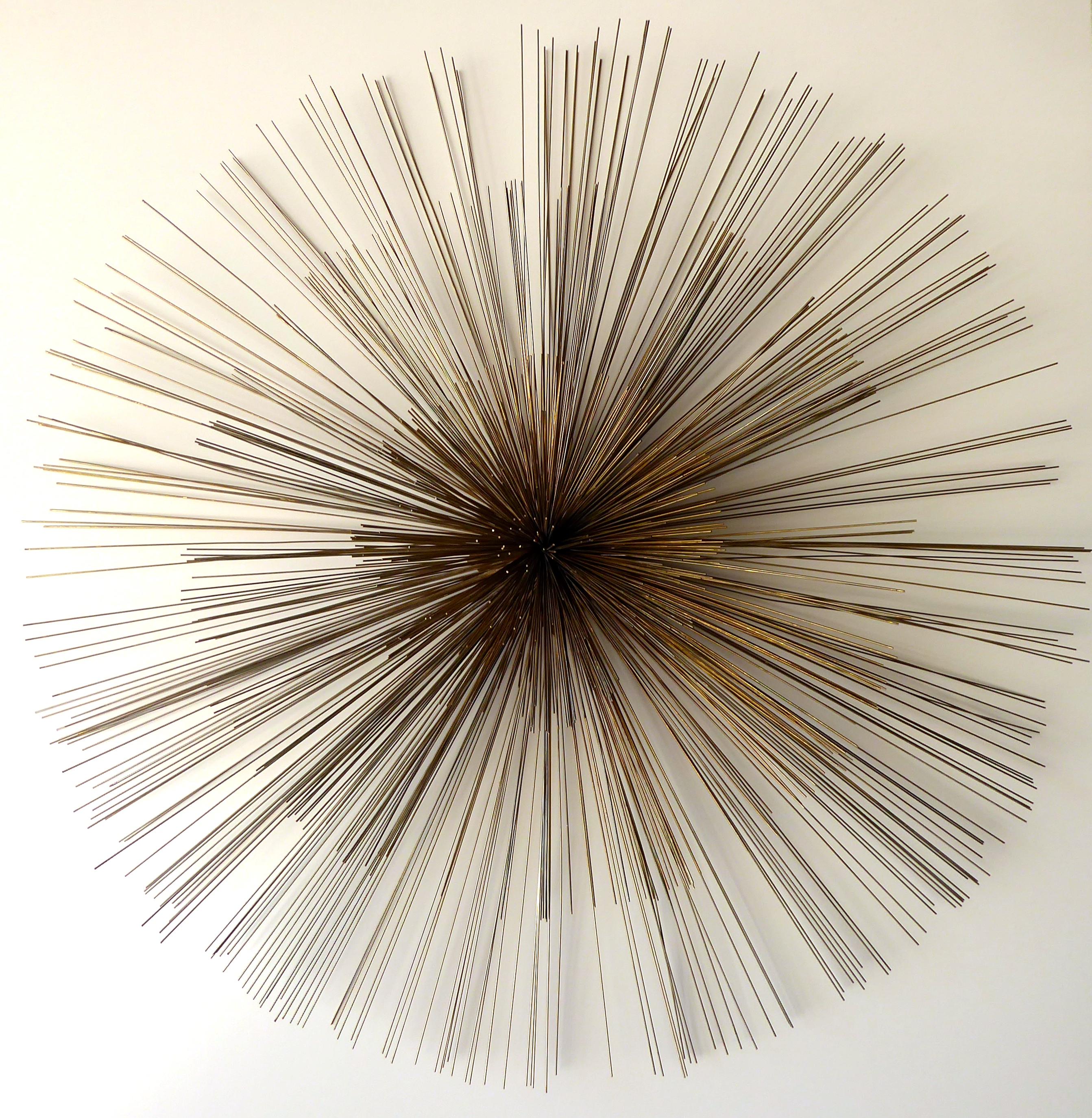 A large metal sea urchin wall sculpture by Artisan House or Curtis Jere, circa 1970s. The thin rods are a subtle combination of silver and brass and the sculpture has a kinetic quality when brushed against.
 