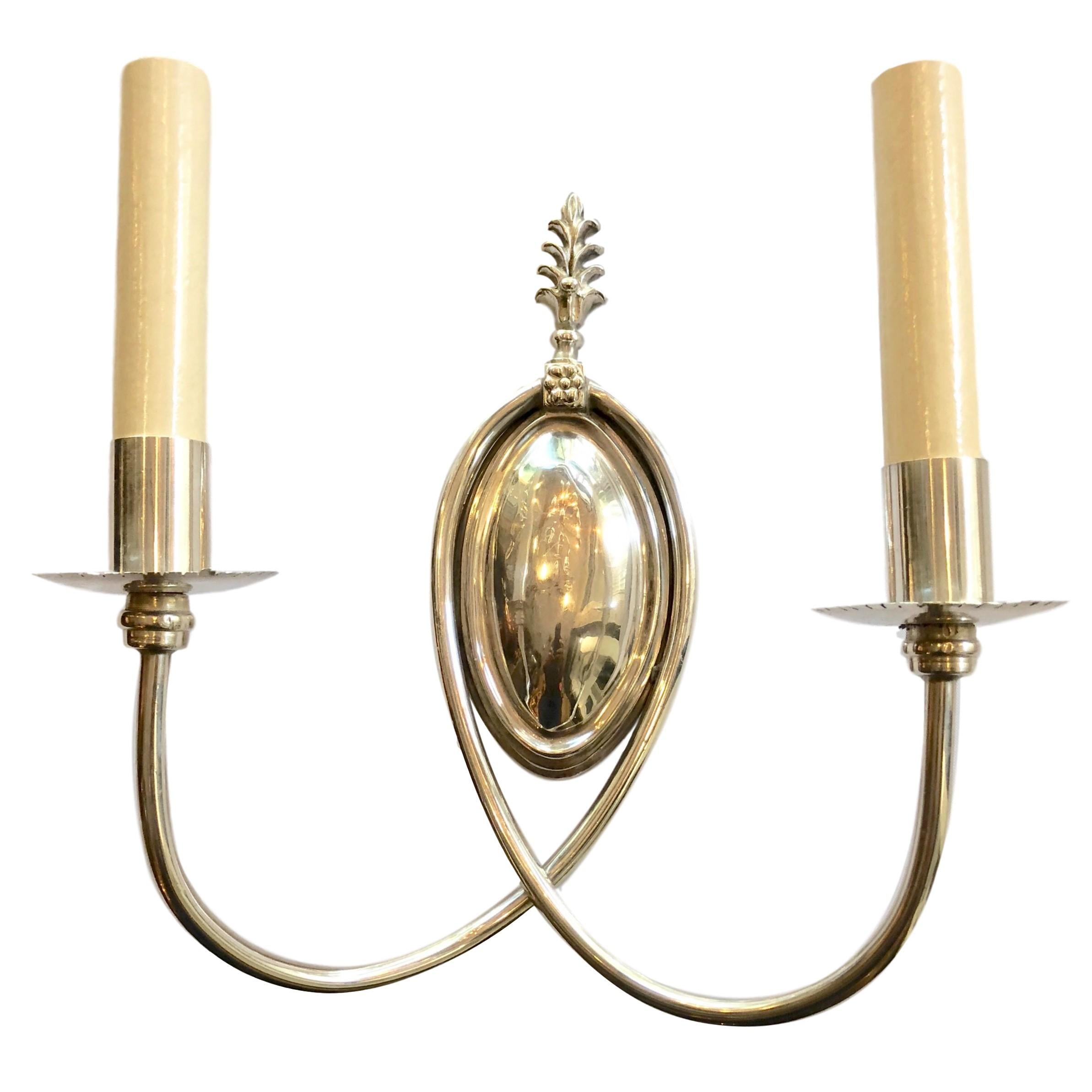 A pair of circa 1920s English silver-plated two-arm sconces.

Measurements:
Height 10