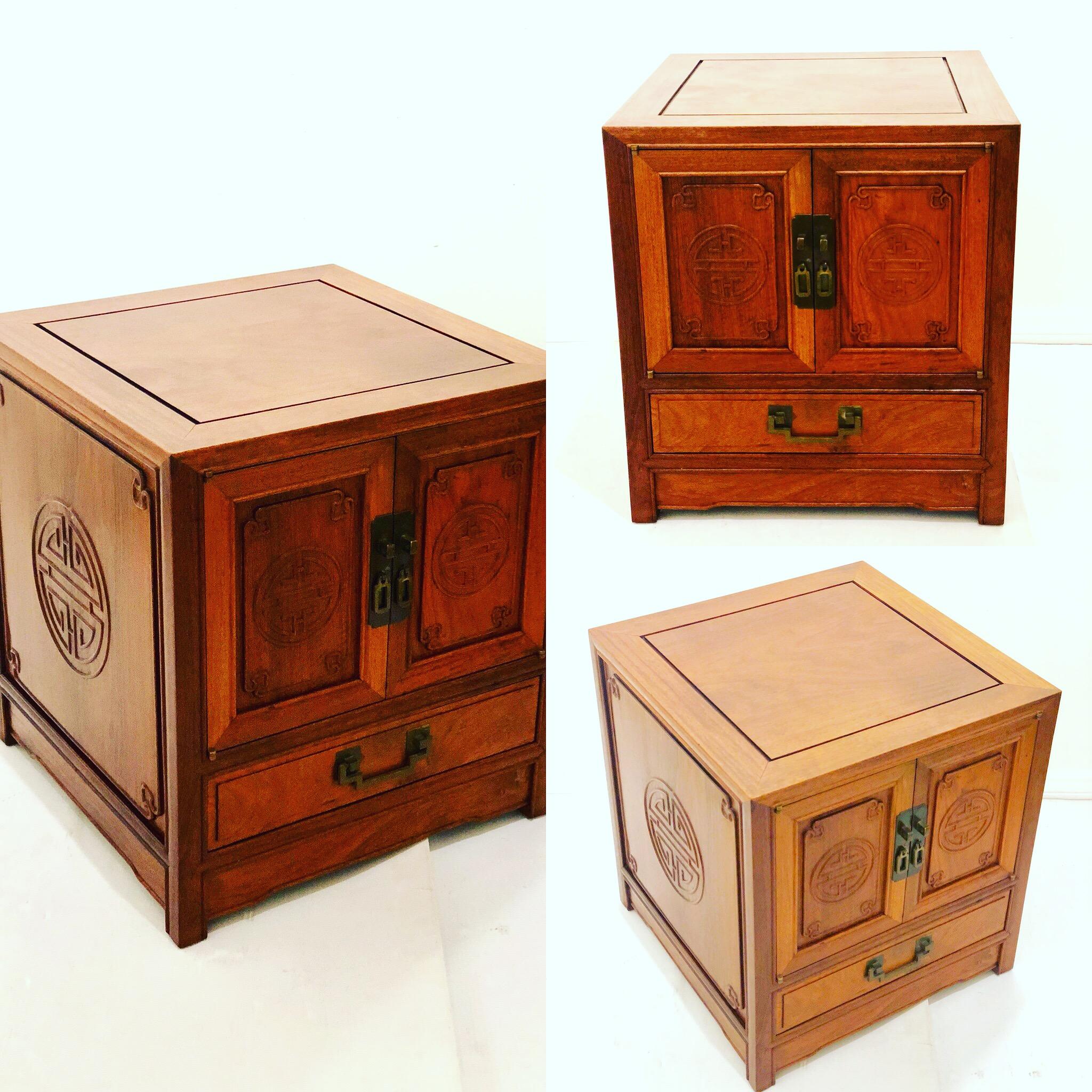 Beautiful and versatile small double door cabinet in solid rosewood with solid brass handles and side carvings nice quality, original condition we have cleaned and oiled its nice and clean with its original metal label in the back.