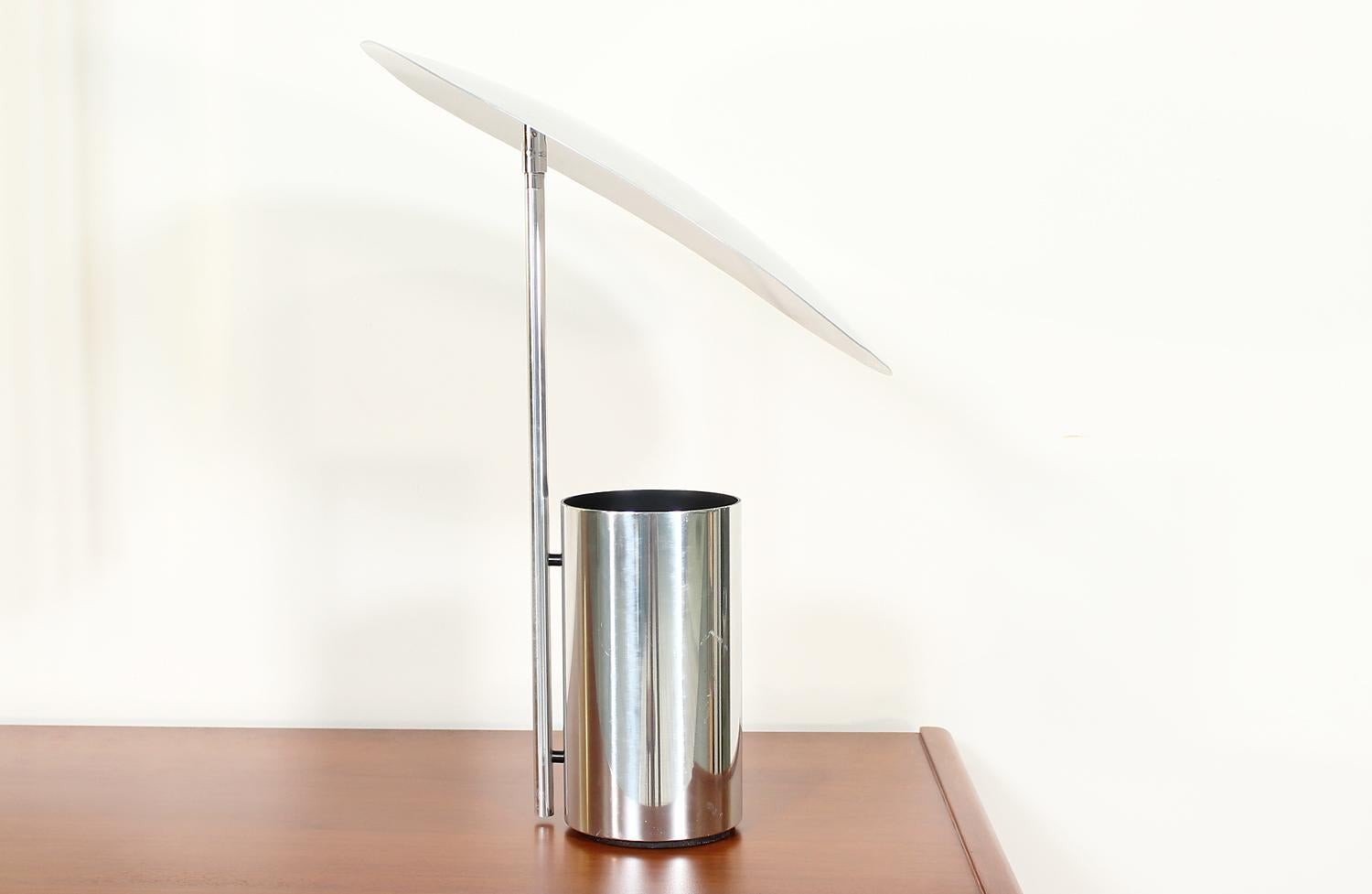 Iconic “Half-Nelson” reflector lamp designed by George Nelson for Koch & Lowy in the United States in 1977. Initially created in the 1950 s, this lamp design wasn’t reproduced until the 1970s. This stunning lamp features a chrome steel cylindrical