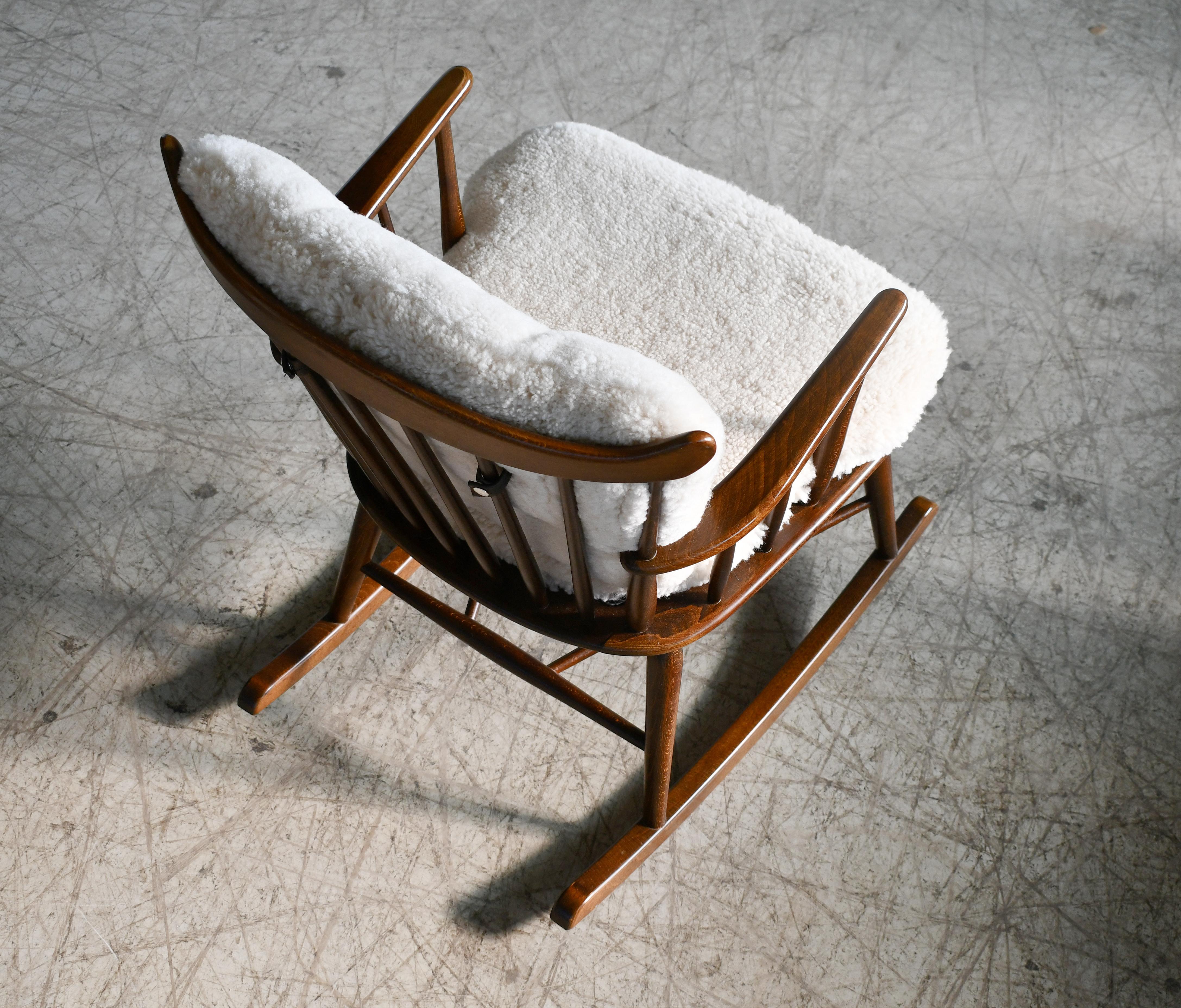 Mid-20th Century Faarstrup 1950 Low Backrest Spindle Back Rocking Chair with Shearling Cushions For Sale