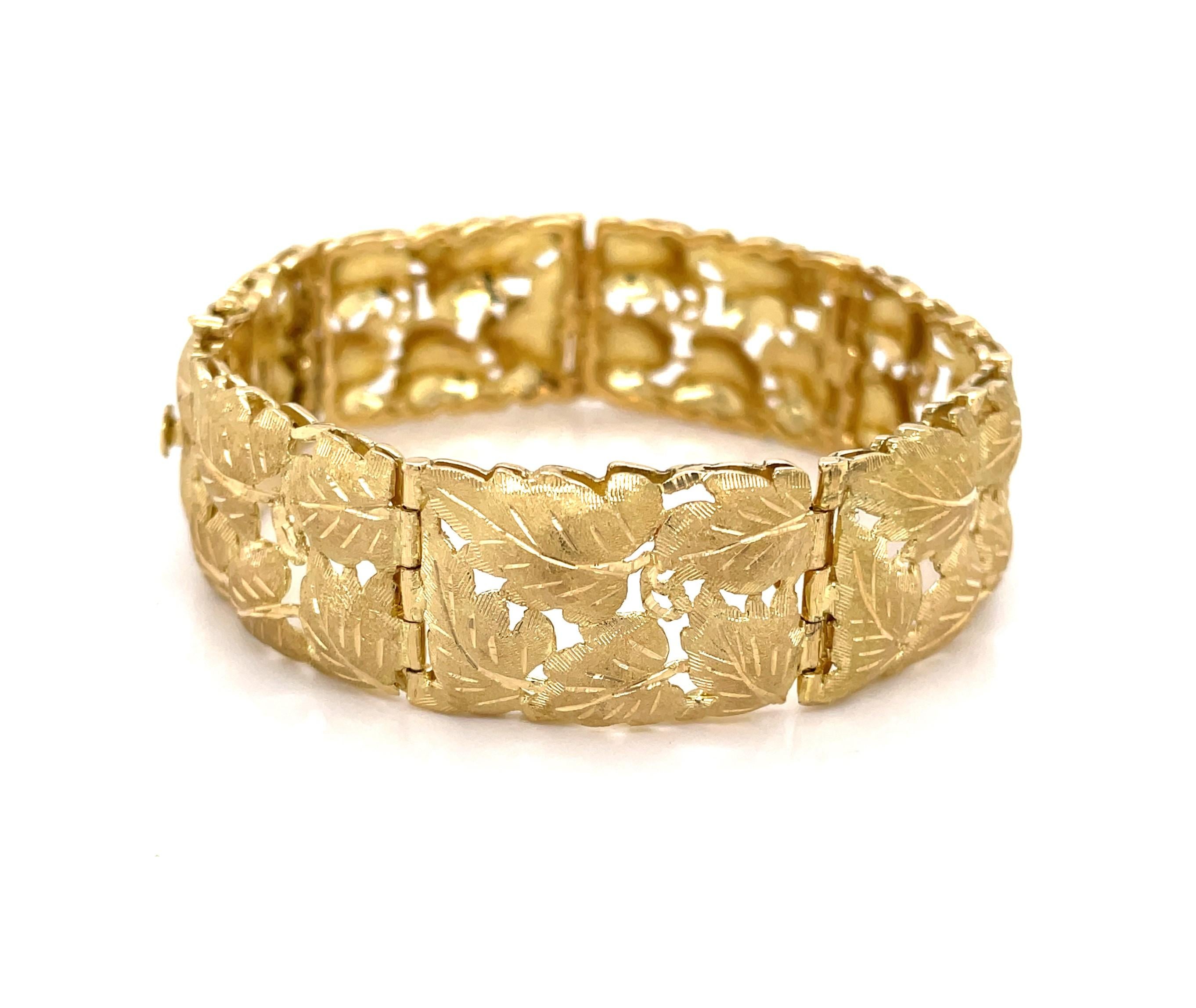 Elegant in 18K eighteen karat yellow gold, this fine link bracelet by Italian designer Fabbrini displays with mixed textures of satin and bright finishes to enhance intricate detail of the grape leaf inspired design. The pleasing open lattice