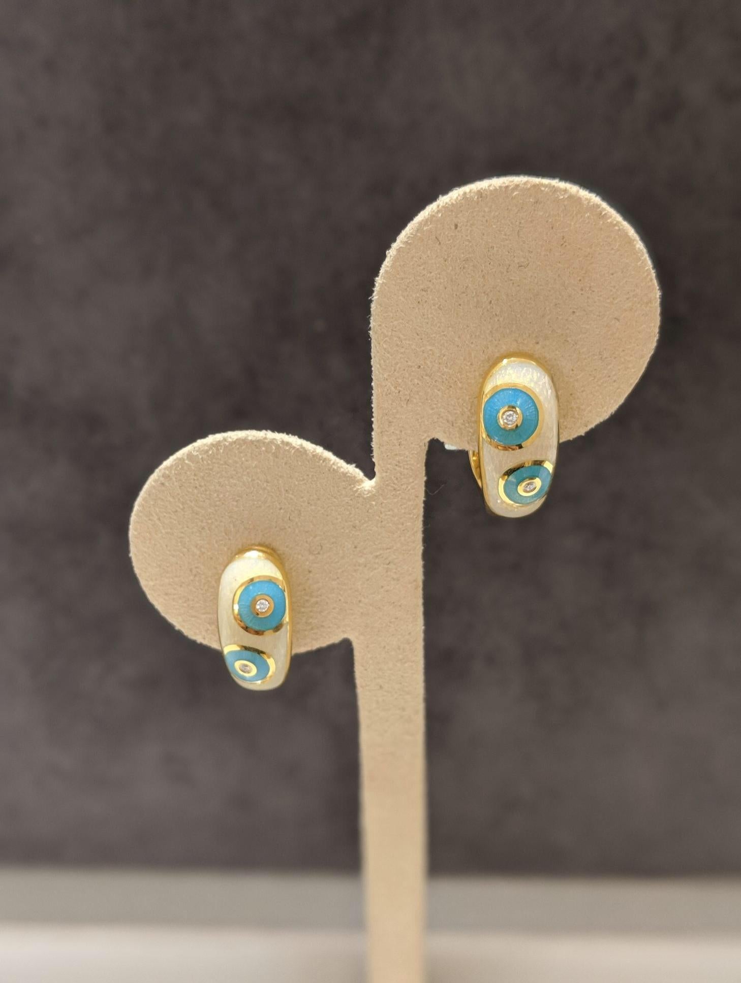 These classic huggy earrings are crafted using the traditional Faberge guicholle enameling technique.
Crafted with seven layers of white and turquoise enamel in a dot pattern and further enhanced with round brilliant diamonds. These earring are with