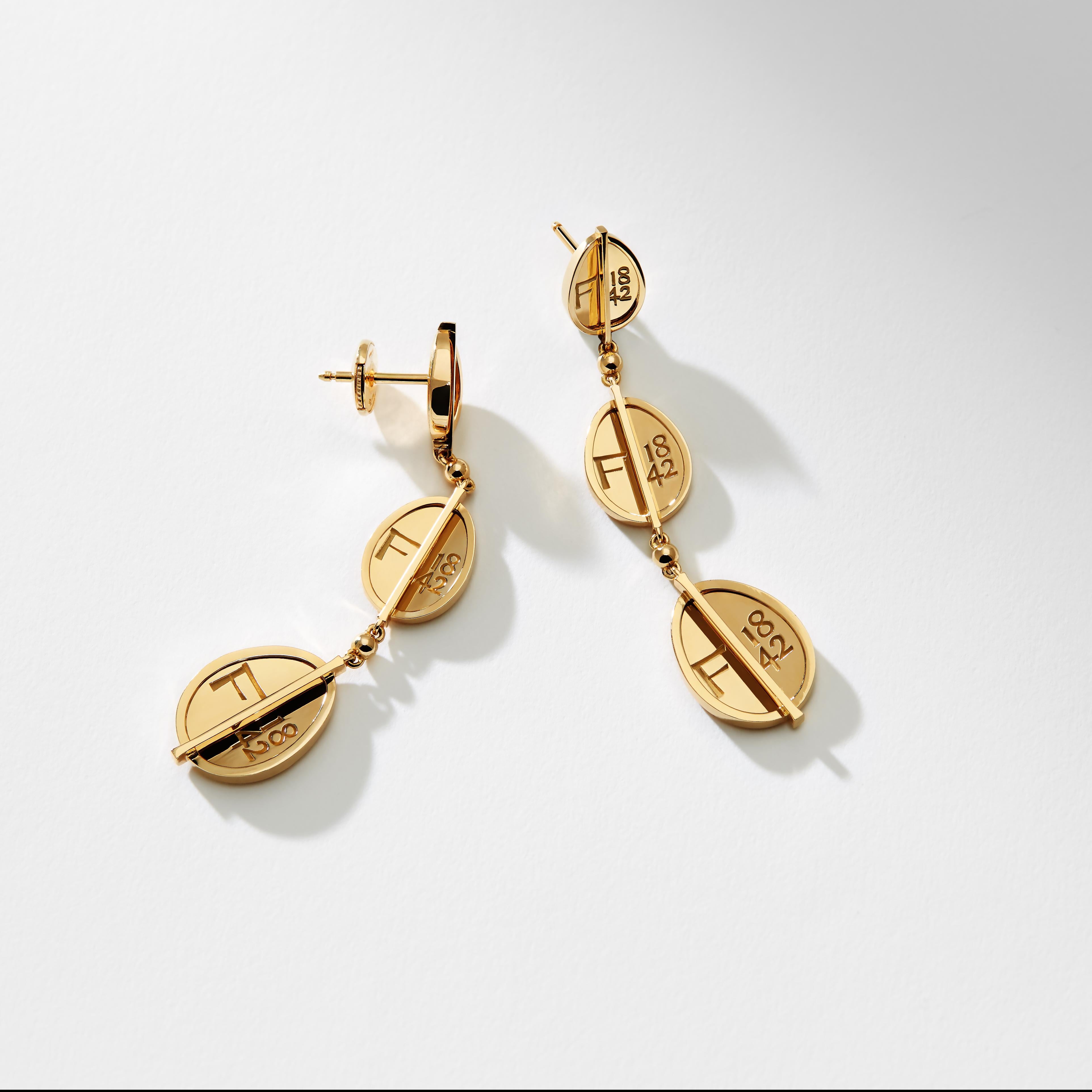 The Fabergé 1842 Yellow Gold Egg Drop Earrings each feature three egg shaped Fabergé hallmarks set in 18 karat yellow gold. The earrings are 55mm in length, 12mm at the widest point and 2.5mm in depth. In keeping with Fabergé’s penchant for