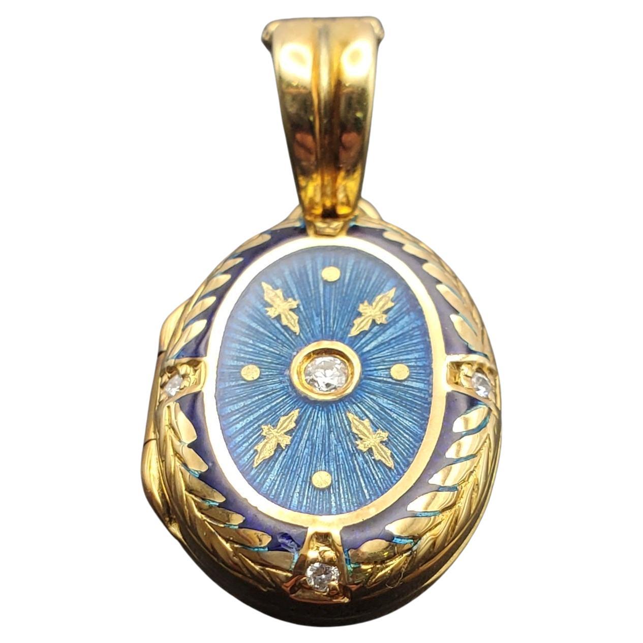 Gorgeous handmade 18k gold, diamond, and guilloche enamel locket. This limited edition piece was designed by Victor Mayer for Fabergé. The design features vibrant blue transparent enamel that has been applied over the top of an intricate starburst