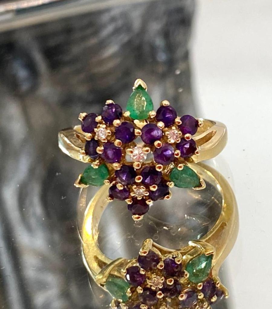 Faberge 18k Gold Ring With Diamonds, Amethyst & Emeralds.

Featuring three flowers made up of Amethyst, with central Diamonds and Emerald representing leaves.

Design by (Franklin Mint).

Size - 56

Condition - Very Good 

Composition - 18k Gold,