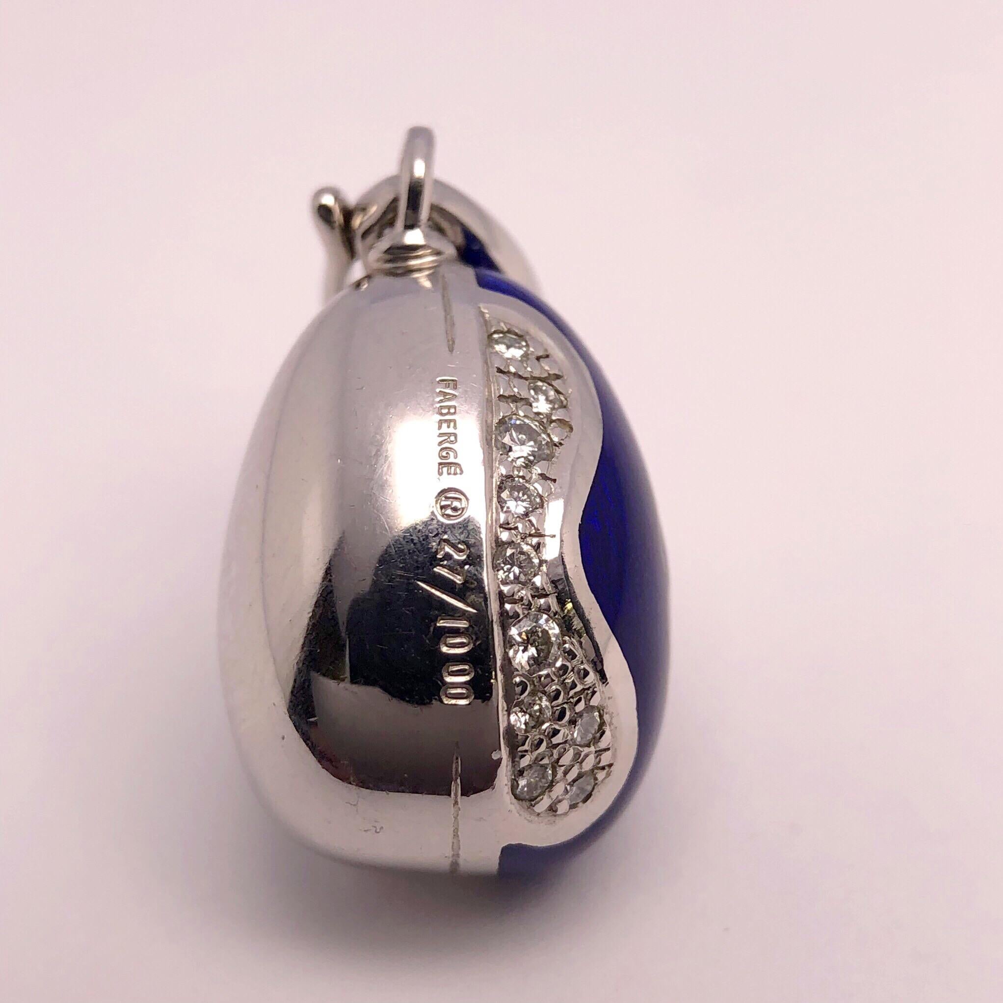 This modern 18 karat white gold , diamond and blue enamel egg was created by Victor Mayor. Crafted in the tradition of the original Imperial eggs using Faberges iconic guilloche enameling. A swirl motif is set with white diamonds on either side.