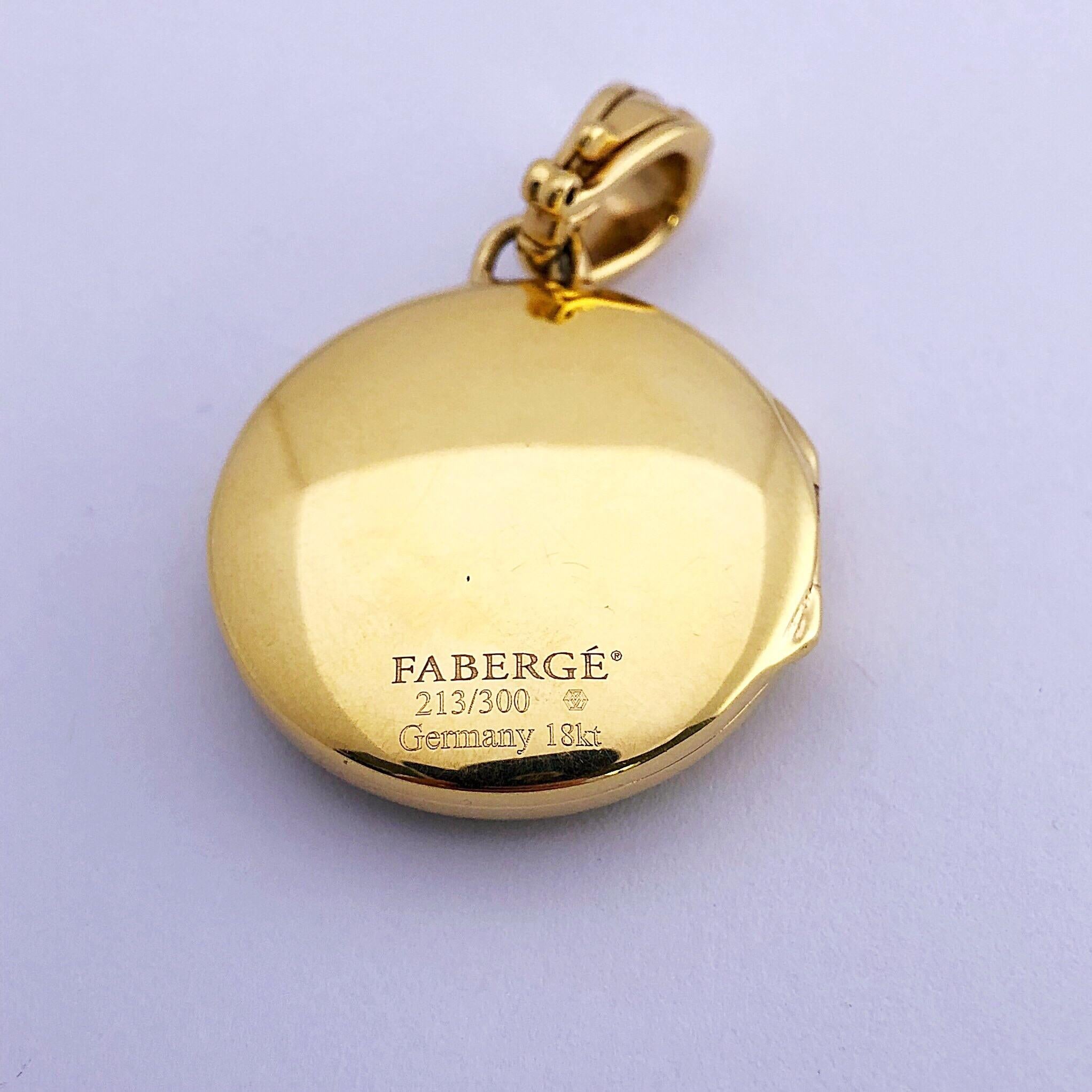 This modern 18 karat yellow gold and enamel  locket was created by Victor Mayer. Crafted in the tradition of the original Imperial eggs, this pendant locket was beautifully with Faberges iconic guilloche enameling in chartreuse green, and contains