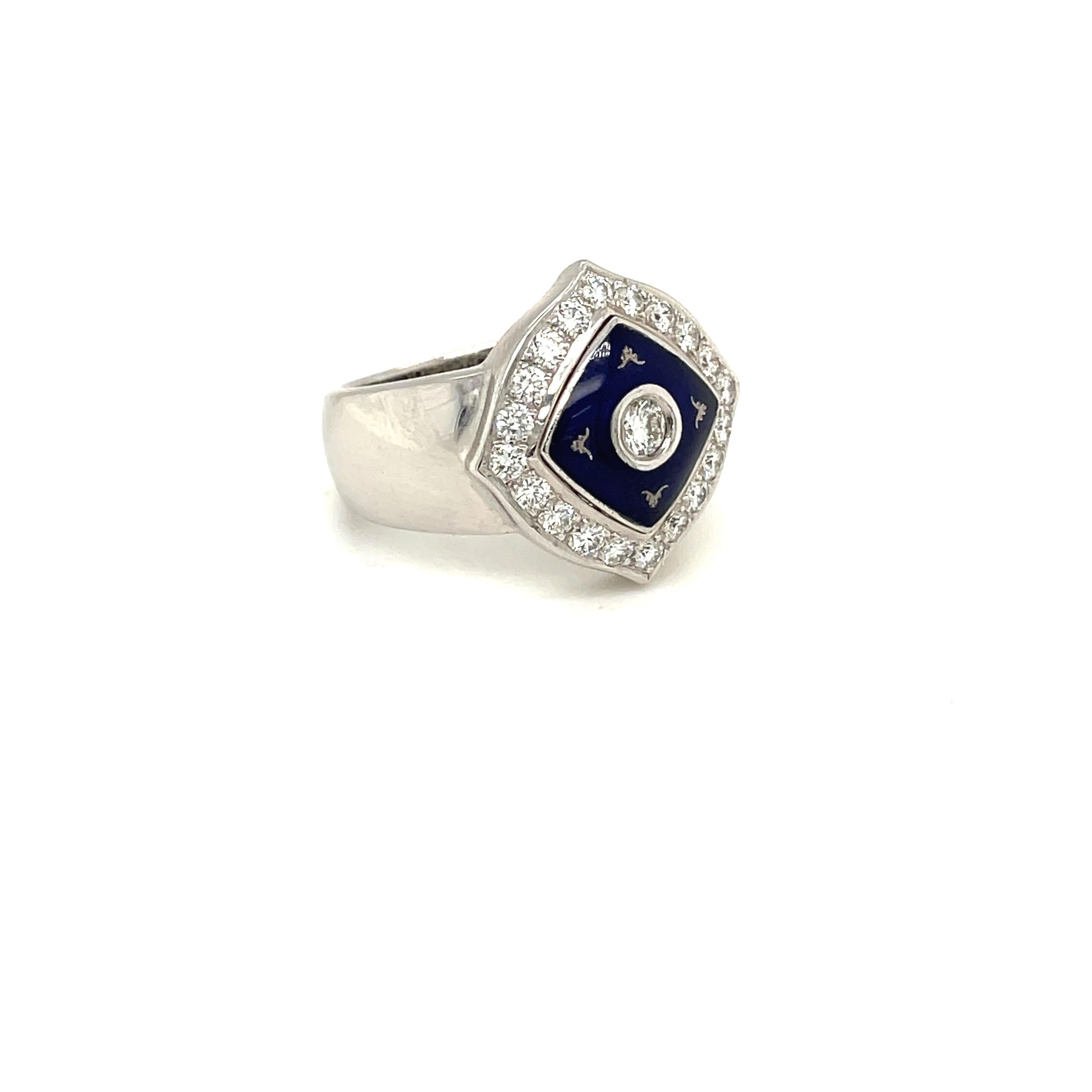 This modern Faberge 18 karat white gold cushion shaped ring centers a bezel set round brilliant diamond. A raised square of Prussian Blue enamel surrounds the center diamond. Round brilliant white diamonds border the entire ring.
The ring was