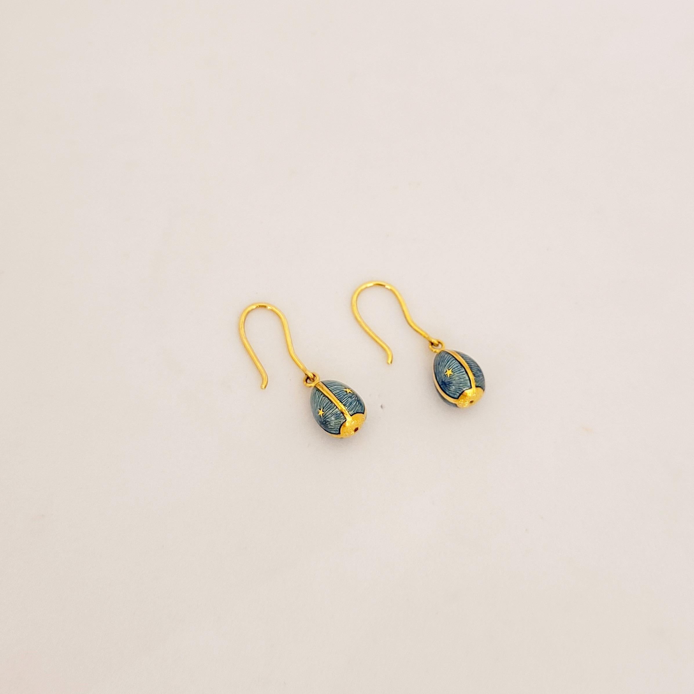 These modern 18 karat yellow gold Faberge earrings were crafted by Victor Mayer. Each earring features a single egg hanging from a gold wire.The sky blue eggs were crafted in the same tradition of the original Imperial eggs using Faberges iconic