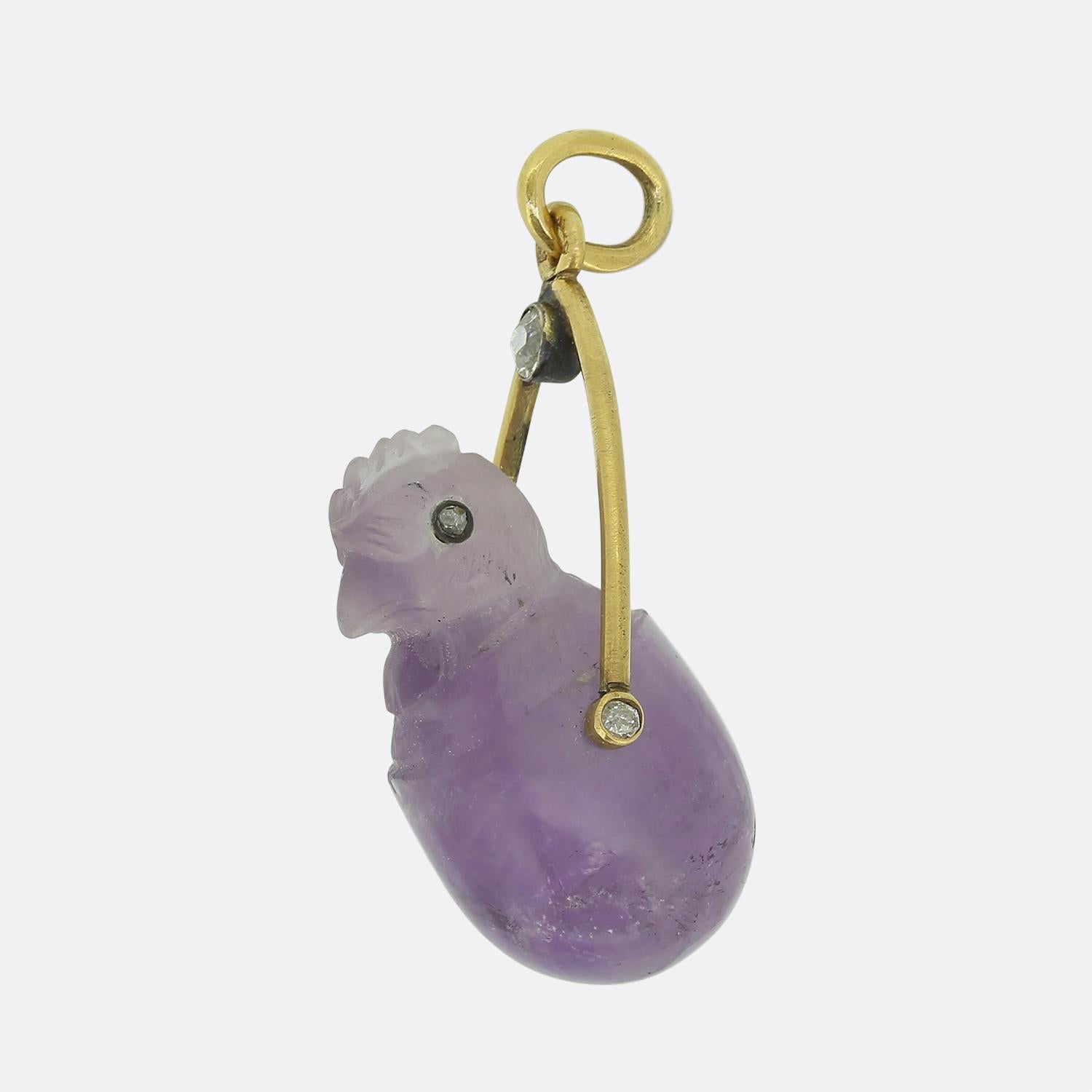 Here we have a remarkable creation from Fabergé. This pendant features a highly detailed purple amethyst which has been carved into the shape of a small baby hatchling with rose cut diamonds for eyes. It is elegantly framed by a gold arch allowing
