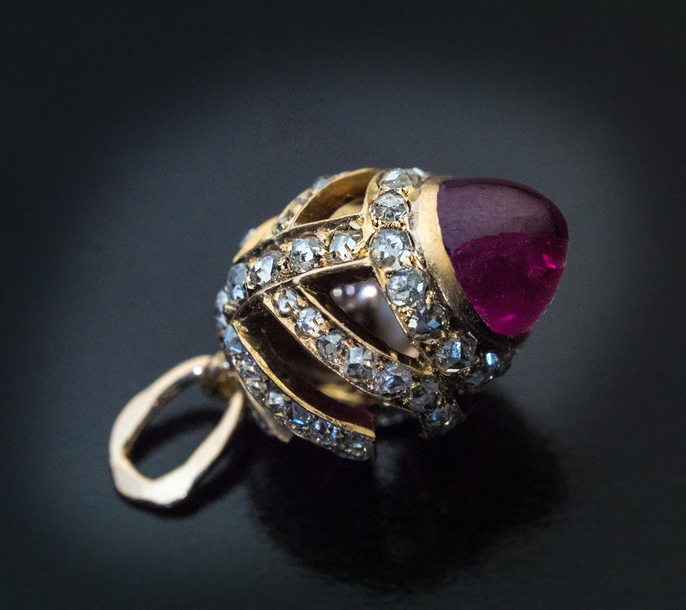 This rare and unusual original FABERGE miniature egg pendant was made in St Petersburg between 1908 and 1917. The openwork 14K gold egg is set with a cabochon cut natural ruby and 72 small rose cut diamonds.

The egg is marked with 56 zolotnik