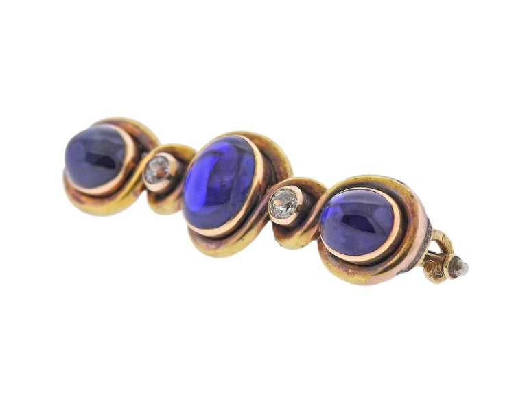 Original Faberge antique 18k gold brooch, with three sapphire cabochons (measuring approx. 8.6 x 7.4mm and 10.6 x 8.4mm) and approx. 0.30cts in diamonds. Brooch is 48mm x 15mm. Marked with a Hallmark on the stem. Weight - 14.1 grams.