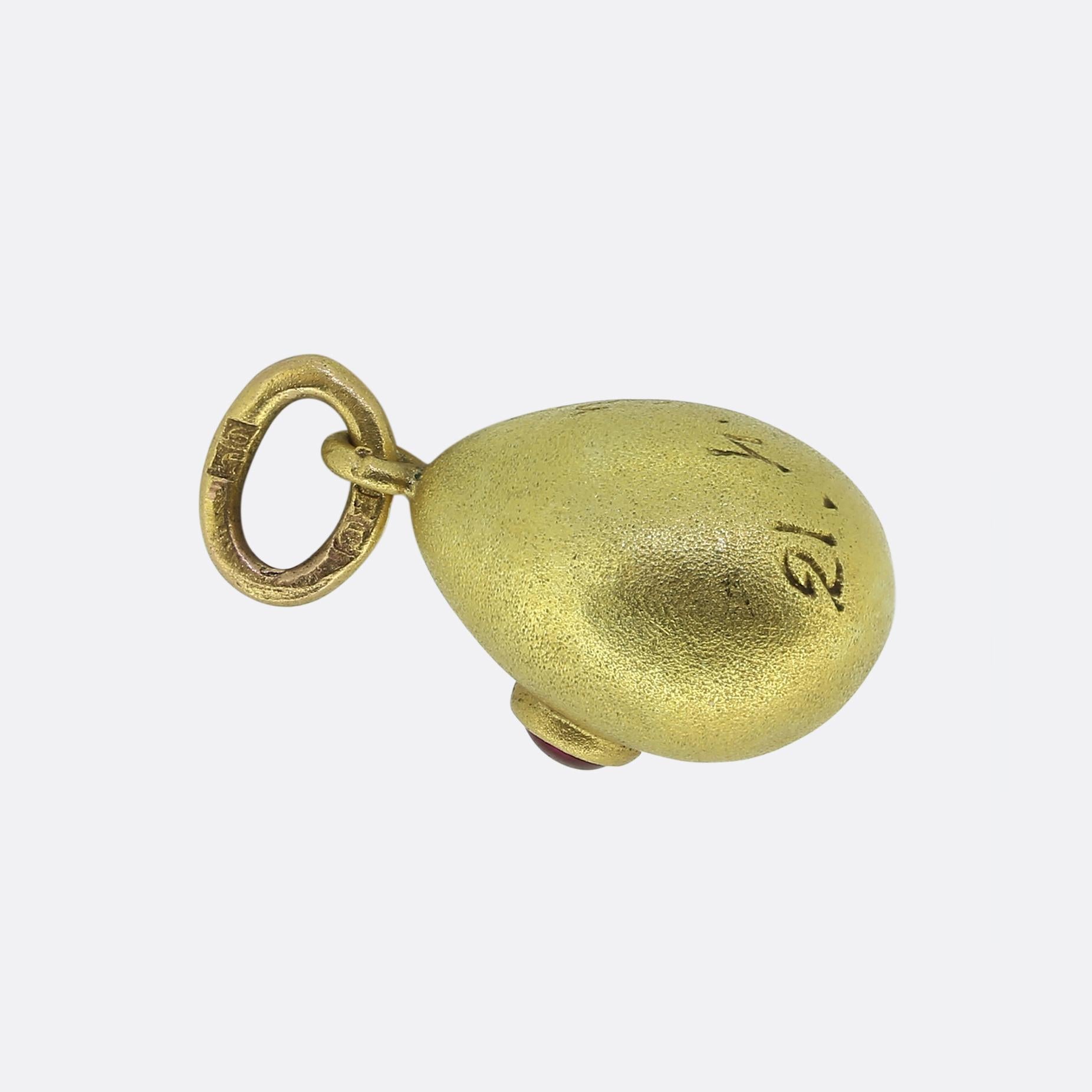 Here we have a classic egg pendant by Fabergé work master, Vladamir Solovyev. This antique piece has been crafted from a rich 14ct yellow gold and features a single round cabochon ruby. This lone stone possesses a deep red hue and has been bezel set