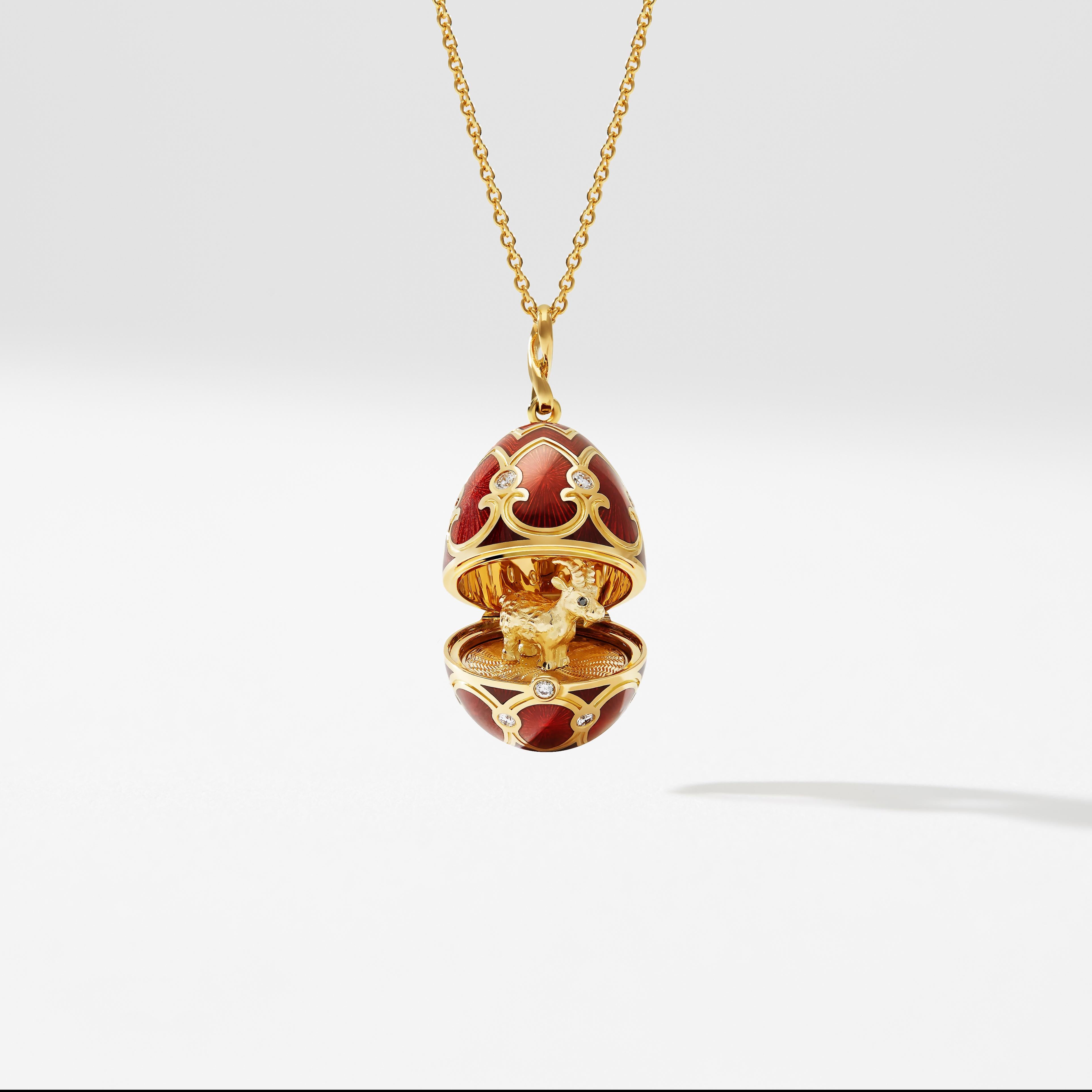 The Heritage Yellow Gold Diamond & Red Guilloché Enamel Year Of The Goat Surprise Locket features red guilloché enamel and round white diamonds, set in 18 karat yellow gold. The locket opens to reveal an 18 karat yellow gold goat with ruby set eyes,
