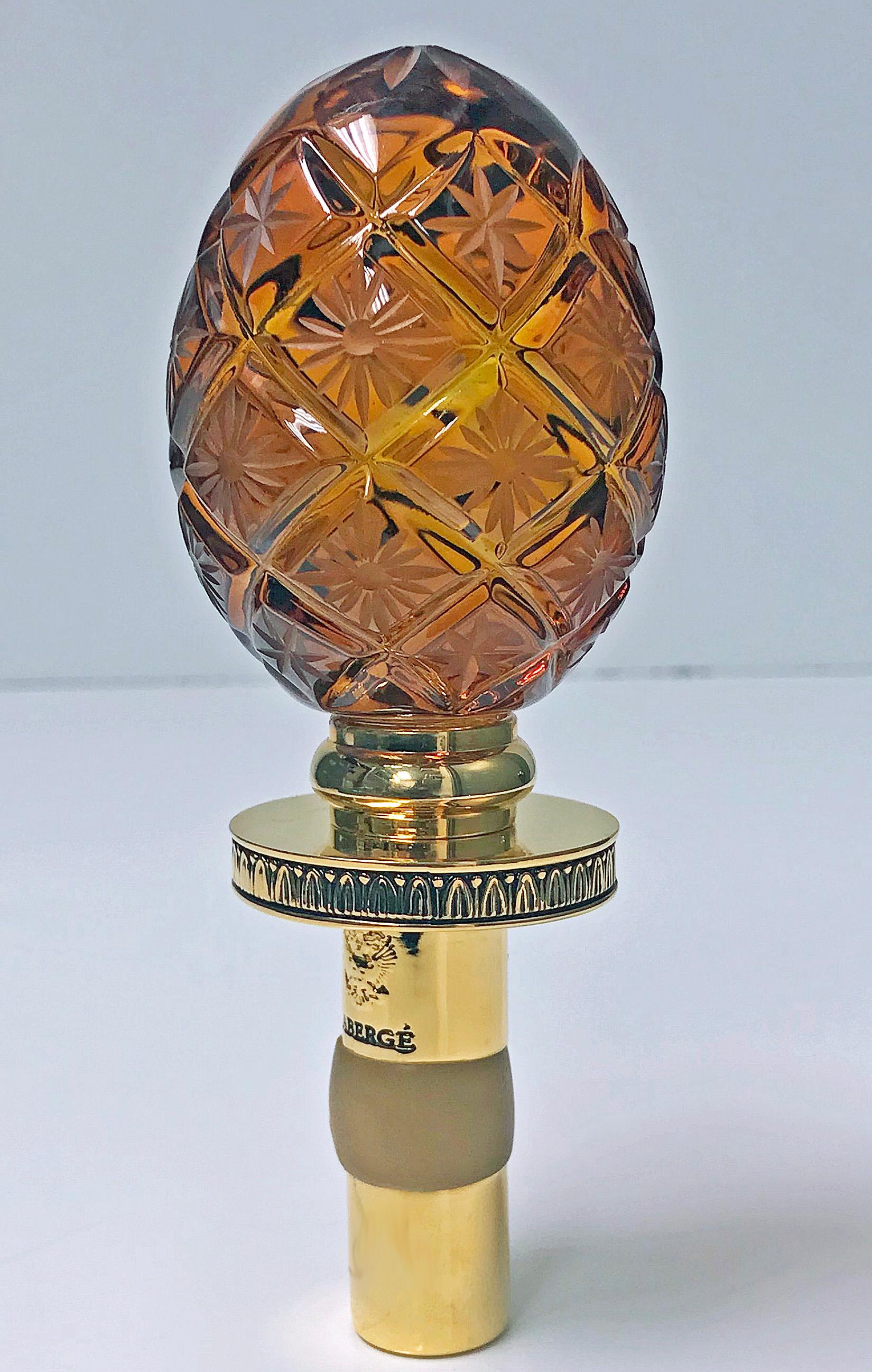 Faberge amber crystal bottle stopper, original box with booklets. Made in Germany. Unused, still in original box. Mounted on a patented expandable and adjustable bottle stopper that fits any size wine bottle and creates an airtight seal. Measures: