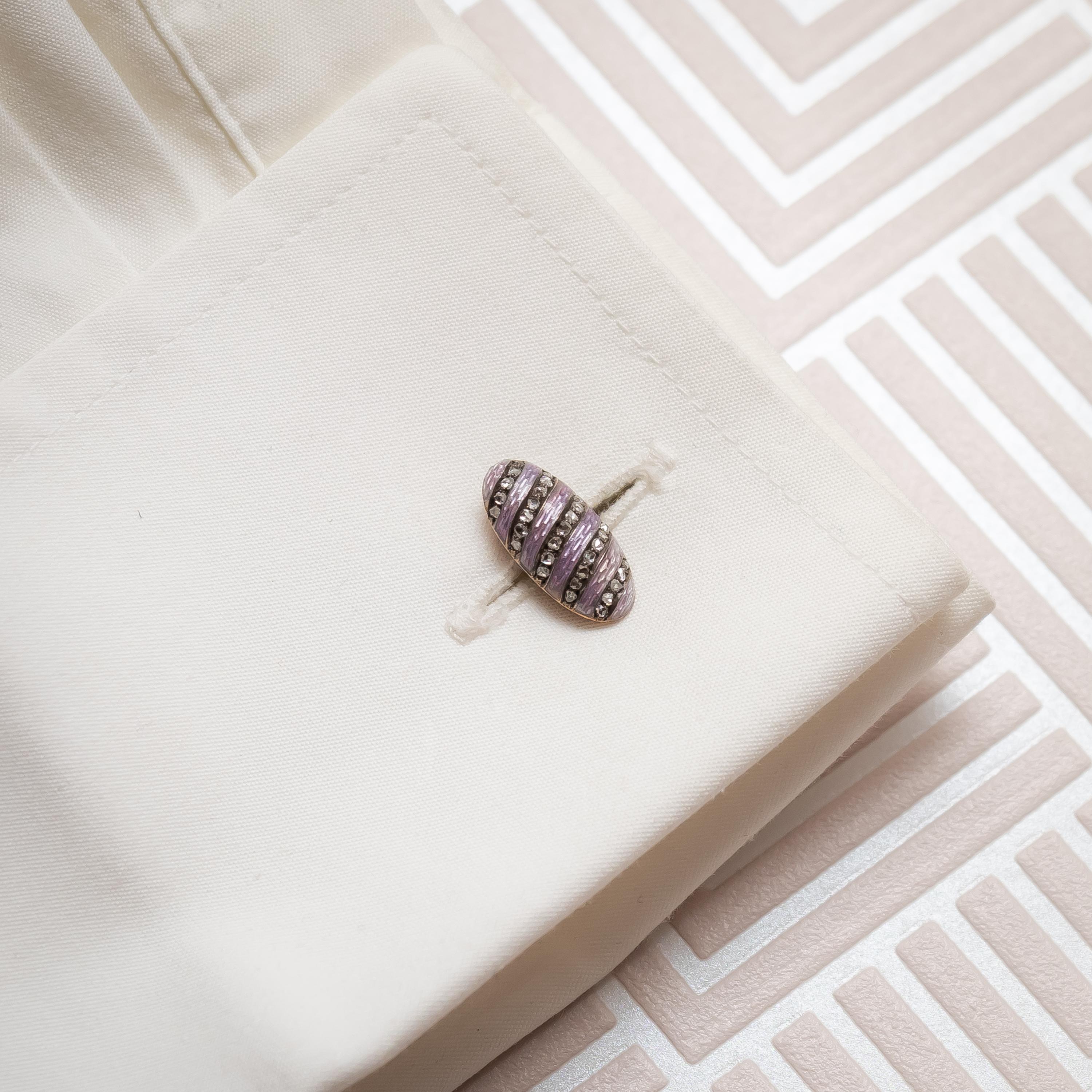 A pair of antique, Fabergé, diamond and enamel cufflinks, with alternating diagonal rows of pale lilac guilloche enamel and rose-cut diamonds, mounted in silver-upon-gold, with chain links. Circa 1899.
Marked AH for Holmström and the coat of arms