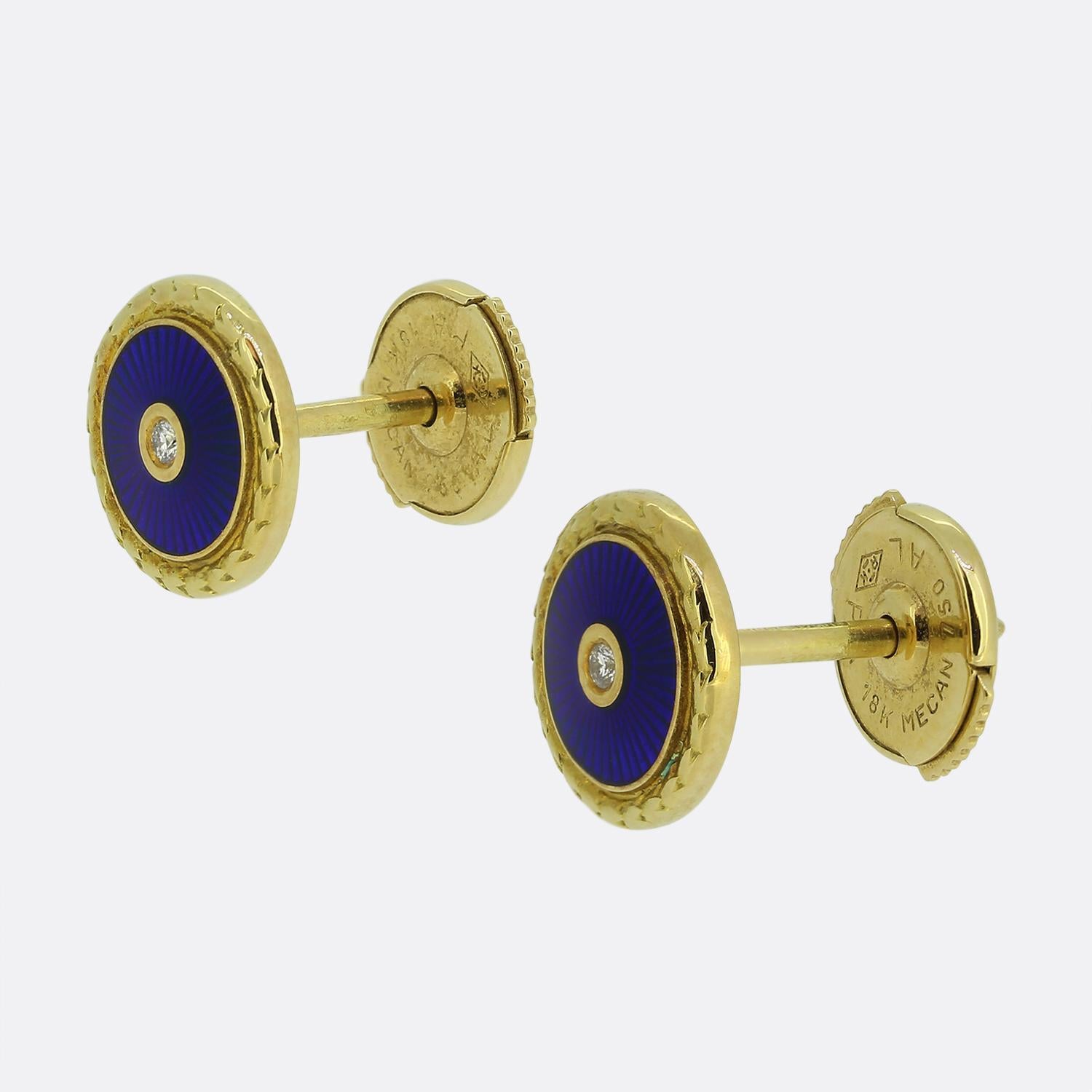 Here we have an exquisite pair of stud earrings from the world renowned luxury jewellery designer, Fabergé. Each identical circular earring features a centralised round brilliant-cut diamond set atop a deep navy blue guilloché enamelled backdrop.