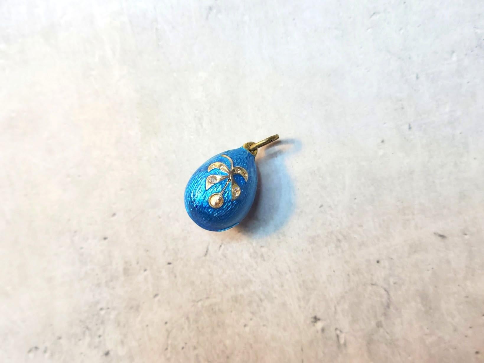 A Fabergé workmaster Anders Johan Nevalainen gilt silver egg pendant, guilloche azure enameled and featuring an embossed image of a berry with a branch with seven simulated diamonds, was made in St. Petersburg, Russian Empire, in the late 19th