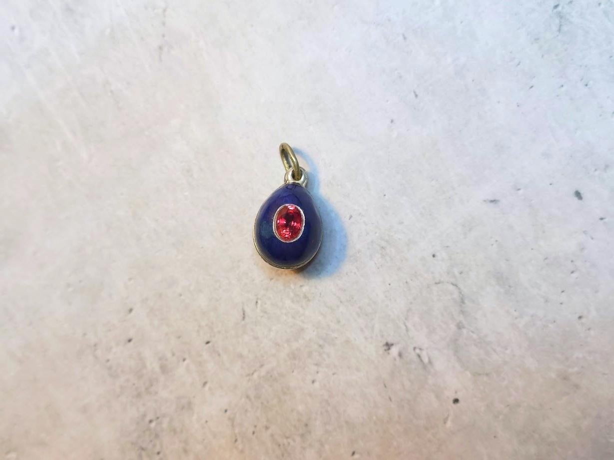 This Fabergé pendant, a rare and historically significant piece, was crafted by the renowned workmaster Phillip Theodore Ringe. This silver egg is covered in beautiful blue guilloché enamel and set with a single-faceted spinel gemstone. Its creation