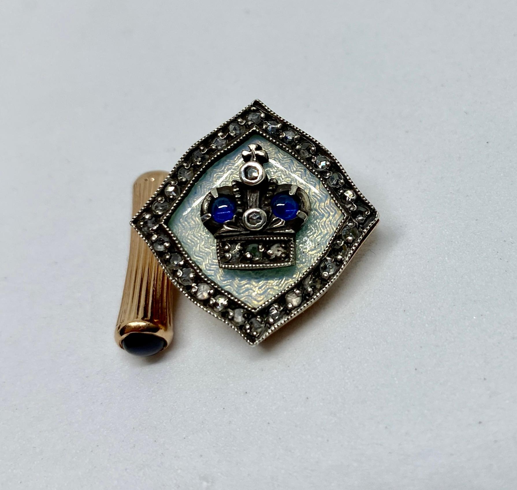 Stunning Imperial Russian cufflinks featuring a silver crown holding five rose-cut diamonds and two cabochon-cut sapphires on a white guilloché field.

These cufflinks were made in St. Petersburg around the turn of the 20th Century by Fabergé