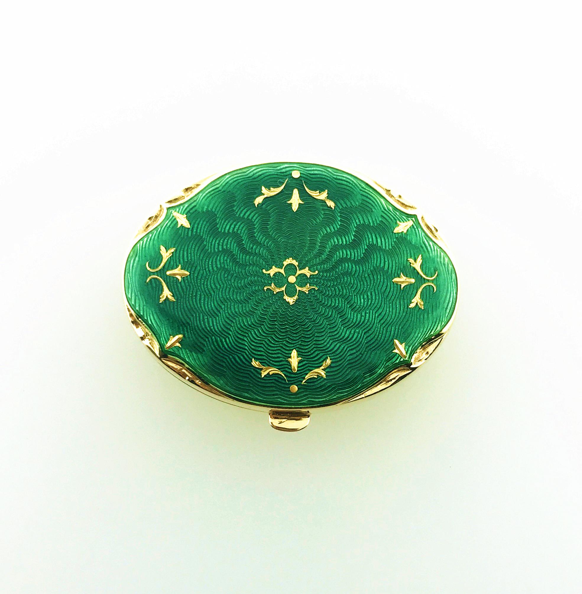 One Fabergé 18-karat yellow gold limited-edition French-guilloché, green enamel, oval-shaped pillbox. The box measures approximately 3.5 cm L x 2.6 cm W x 1.0 cm D and has a hinged emerald-green enameled top embellished with 24-Karat handmade yellow