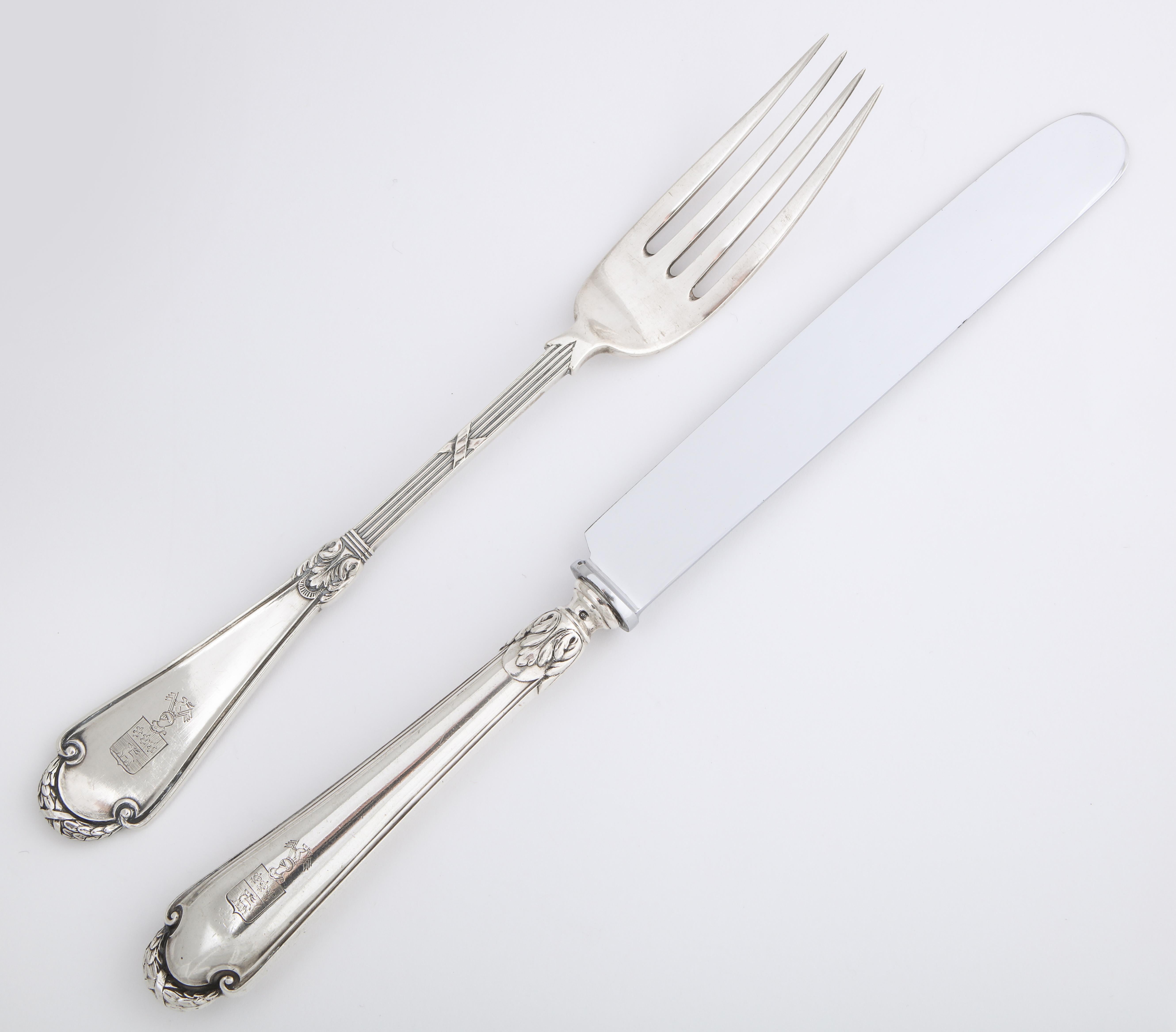 From the Romanov era, period of Tsar Nicholas II, a silver knife and fork pair in the classical taste by Russia’s most famous silversmith, Carl Fabergé, the fork enhanced with reed-and-tie stem and shaped handle, the knife en suite, fitted with a