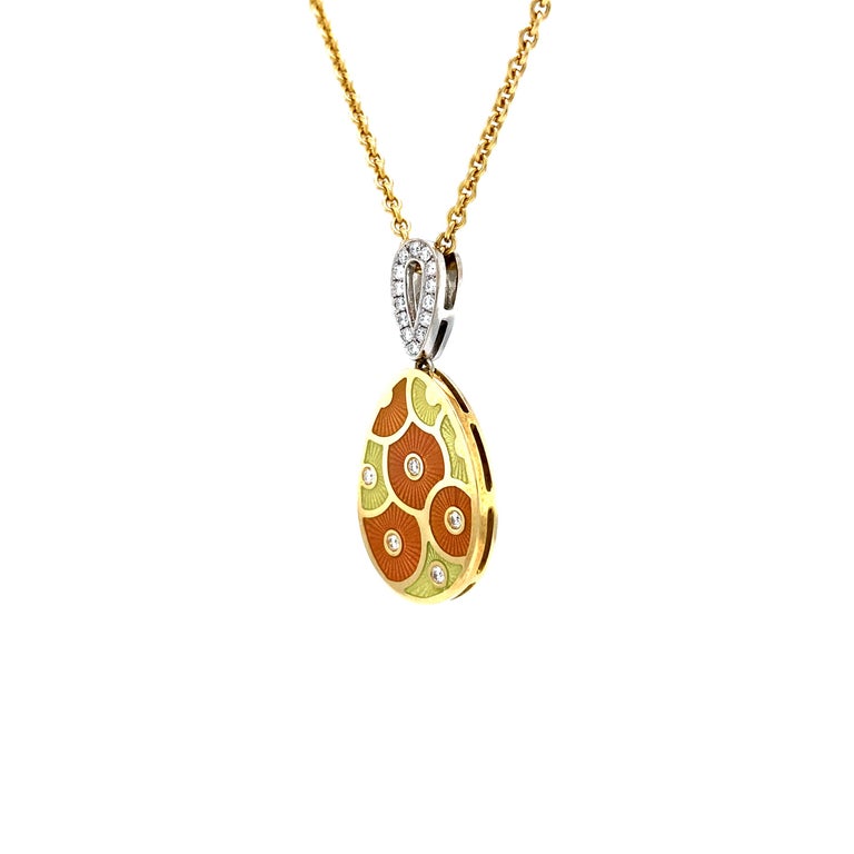 Fabergé oval pendant necklace, limted edition, 18k yellow and white gold, orange & yellow vitreous enamel, 19 diamonds 0,215 ct G/IF, 42 cm

Reference: F2705/Y4/00/00/10442
Brand: Fabergé 
Workmaster: Victor Mayer
Material: 18k yellow gold / white