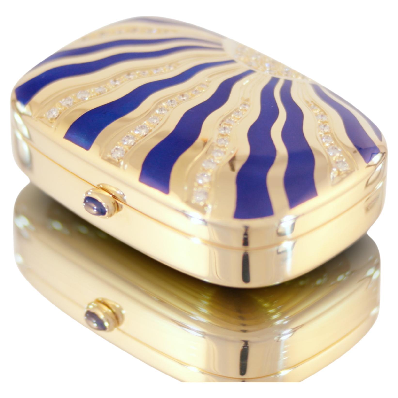 Fabergé Pill Box 18K Yellow Gold, Vitreous Blue Enamel, 51 Brilliant Cut Diamonds 1.2 ct G VS, Sapphire 0.37ct 

This exquisite Fabergé case, crafted from 18k yellow gold in the early 1990s, was produced in the workshop of workmaster Victor Mayer in