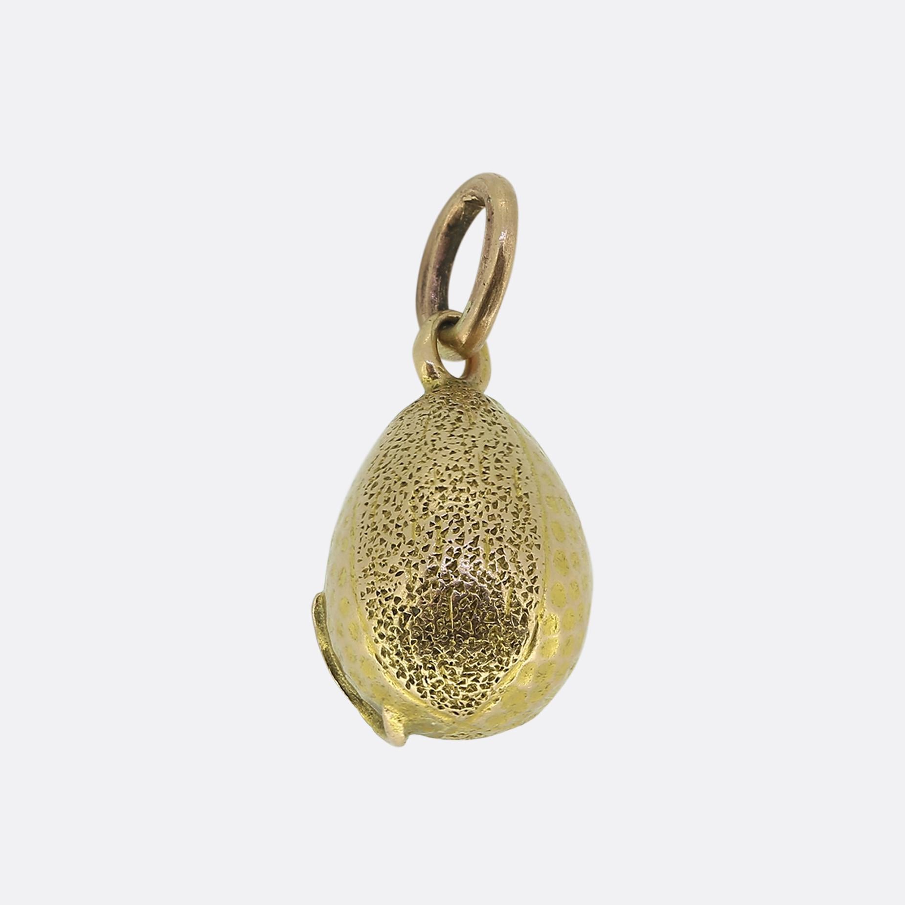 Here we have a charming antique egg pendant from the world renowned luxury jewellery designer, Fabergé. This classic motif has been crafted from a rich 14ct yellow gold and possesses two differing textured finishes. At the centre we find a vibrant