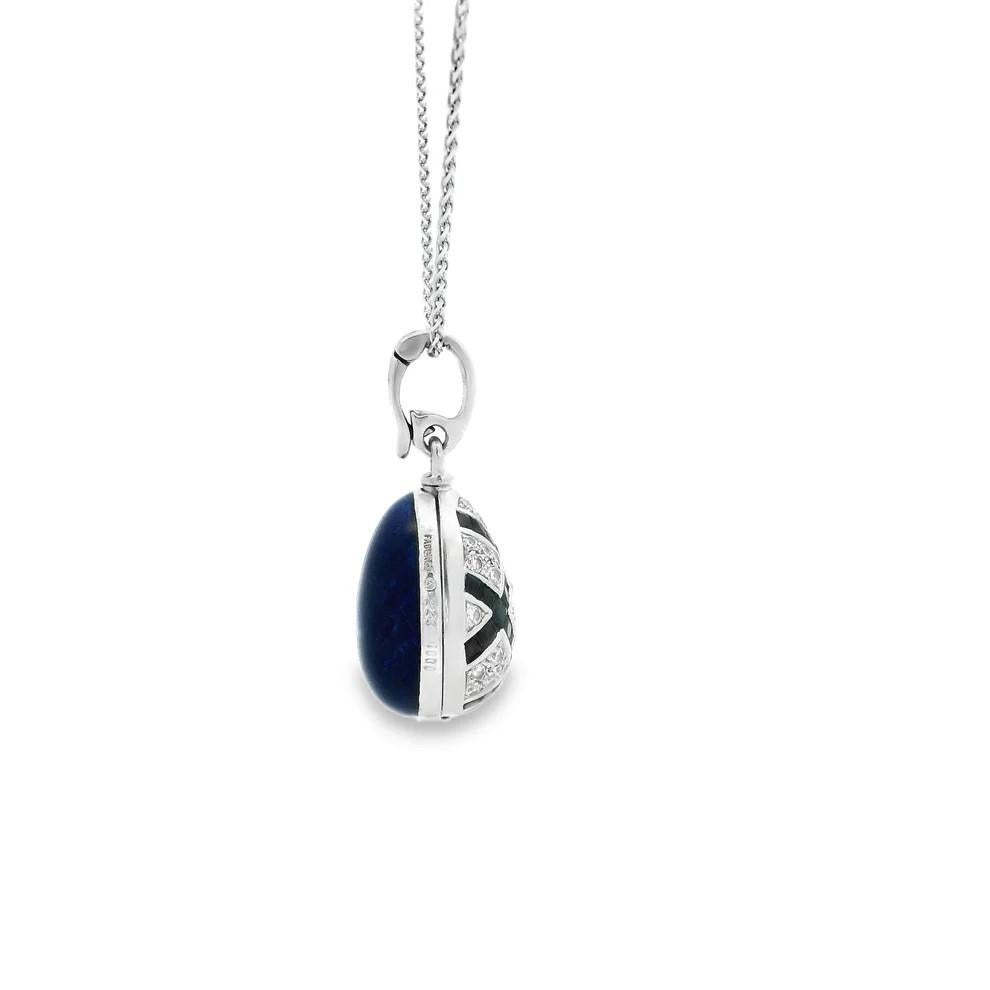 A modern Fabergé sapphire and diamond 18 karat white gold enamel egg pendant 

Designed as an 18 karat white gold egg pendant with Fabergé's signature blue guilloché enamel to one side and featuring a lattice design motif to the other comprised of