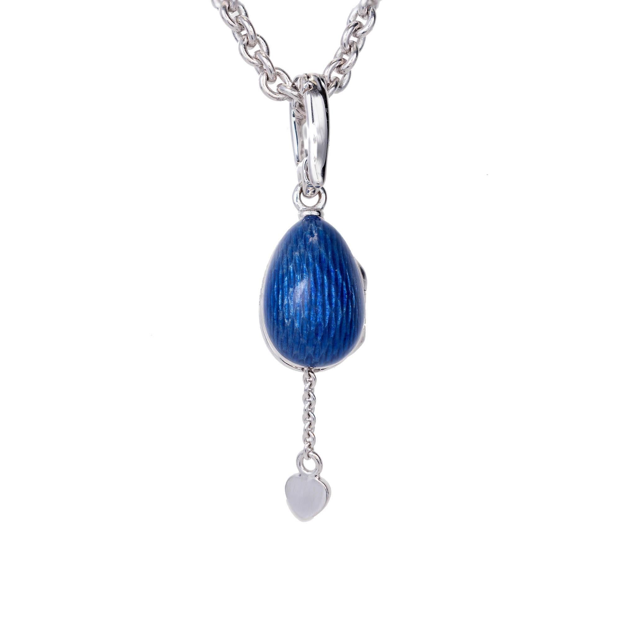 Fabergé Secret Heart egg pendant necklace. In 18k white gold with a hinged enhancer top on a Fabergé 18k 18-inch cable link chain. The egg is a limited edition 419 or 500. The chain is marked 203. Both are signed Fabergé.

1 round Diamond, approx.