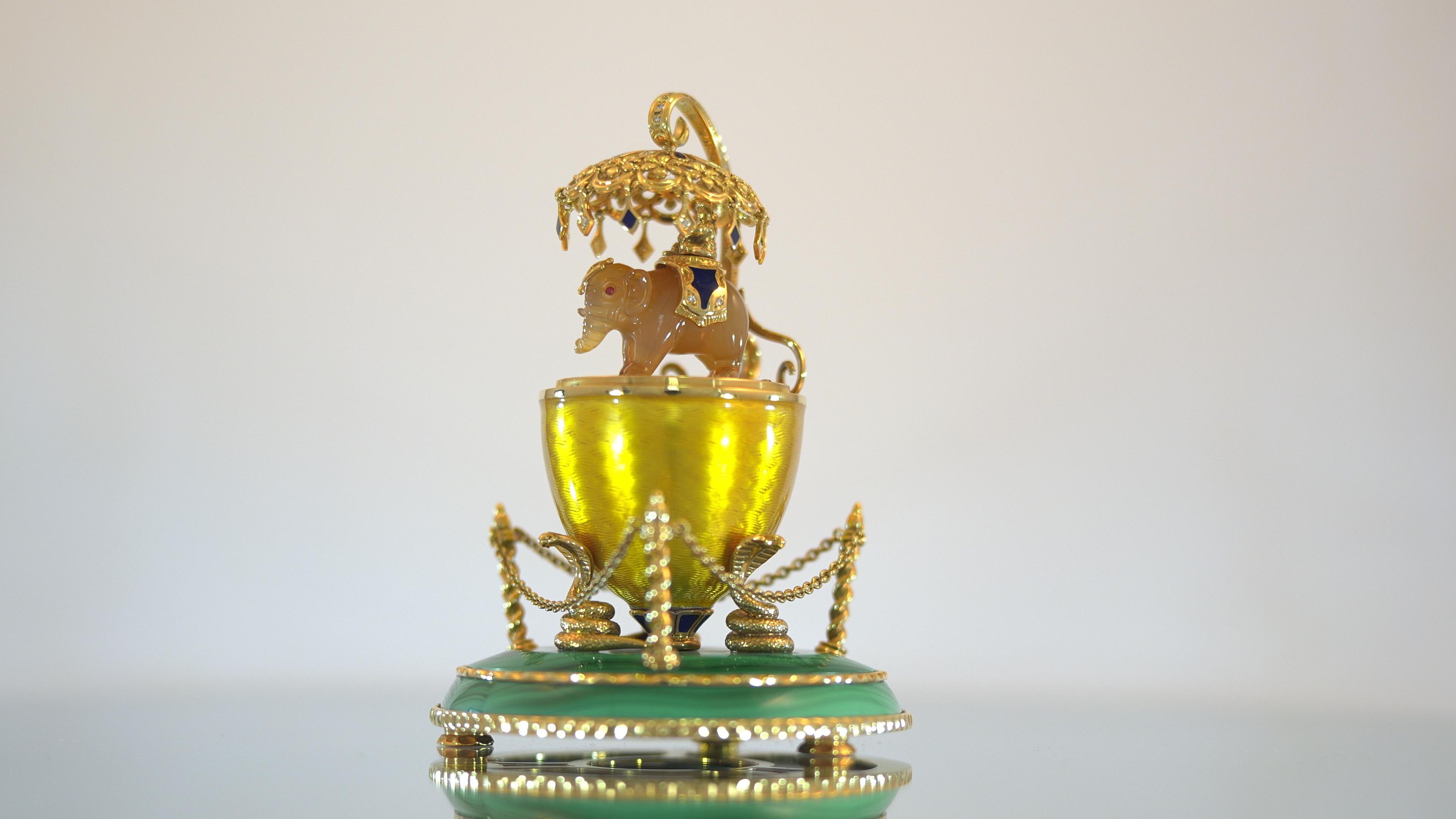 Fabergé Siam Egg, 18k Yellow Gold, Translucent Yellow Guilloché Vitreous Enamel, Diamonds 0.735 ct, Agate, Garnet, Malachite

The Siam Egg, created in 1998, recalls Fabergé’s historic trade relations with the Far East. Among his important patrons