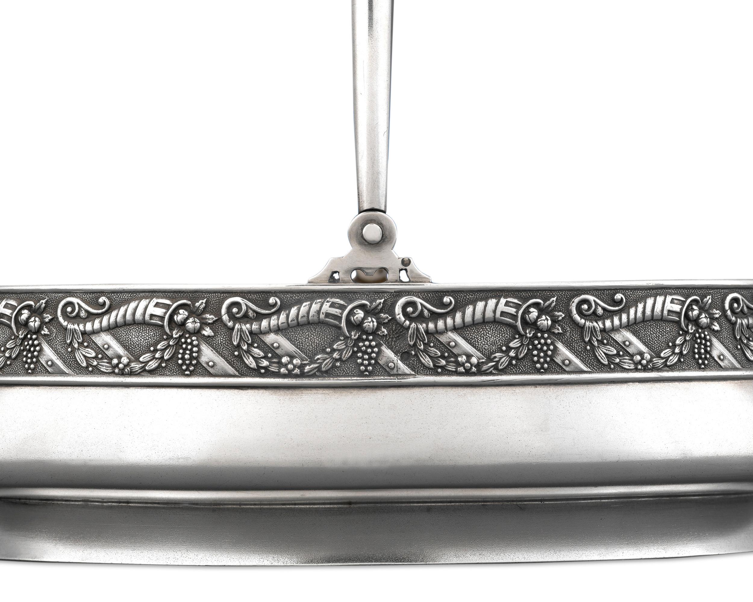This very rare Fabergé silver cake basket was created by work master Stefan Wakeva (Stephan Wäkewä) during his tenure at the Moscow workshop (1908-1917). The simplicity of its form is perfectly complimented by an intricate band of repoussé and