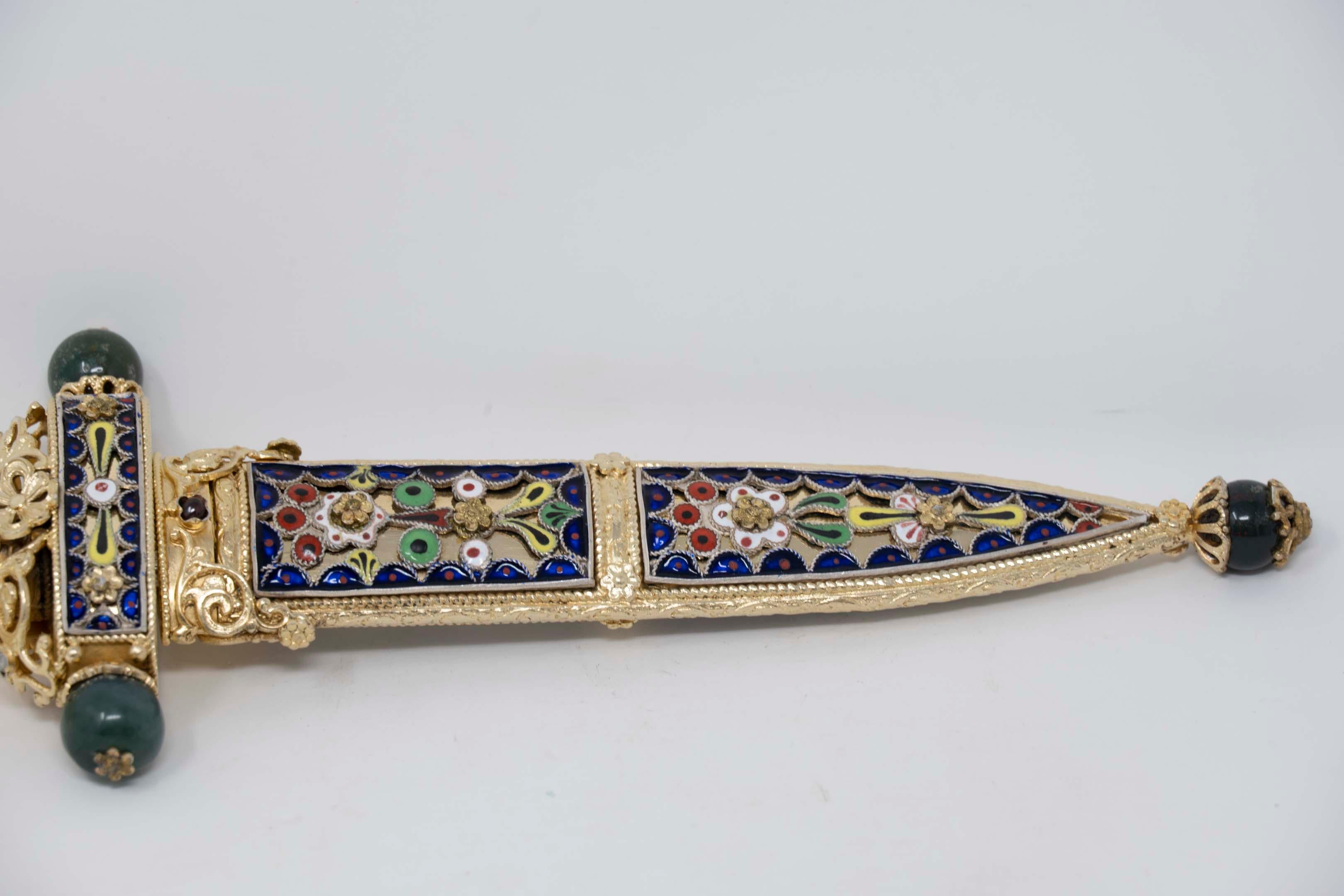 Vintage Faberge style 925 silver marked, letter opener with encrusted jewels jade, turquoise, garnet, enamel and moonstone. Made in the shape of a dagger in a scabbard measures 9 inches long. In excellent condition, blade shows very minor tarnish on