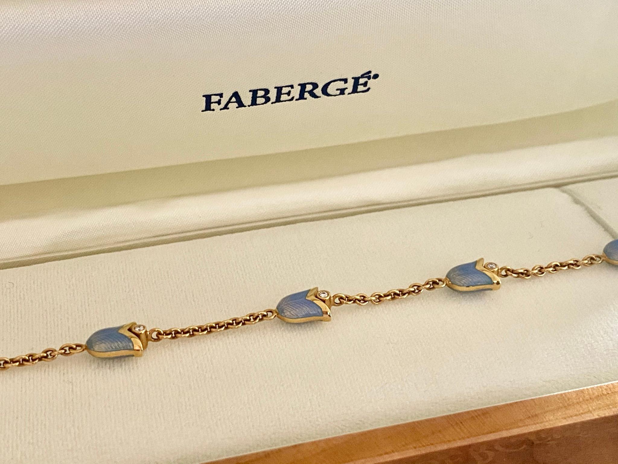 One (1) 18 Karat Gold Bracelet, stamped: 750 & Fabergé   (workmaster: Victor Mayer)
Chain set with 5 Lily of the Valley, with light blue enemal and set with 10 Round Brilliant Natural Diamonds
Weight: 13.62 grams
Lenght of the Bracelet: 19.3 cm  (