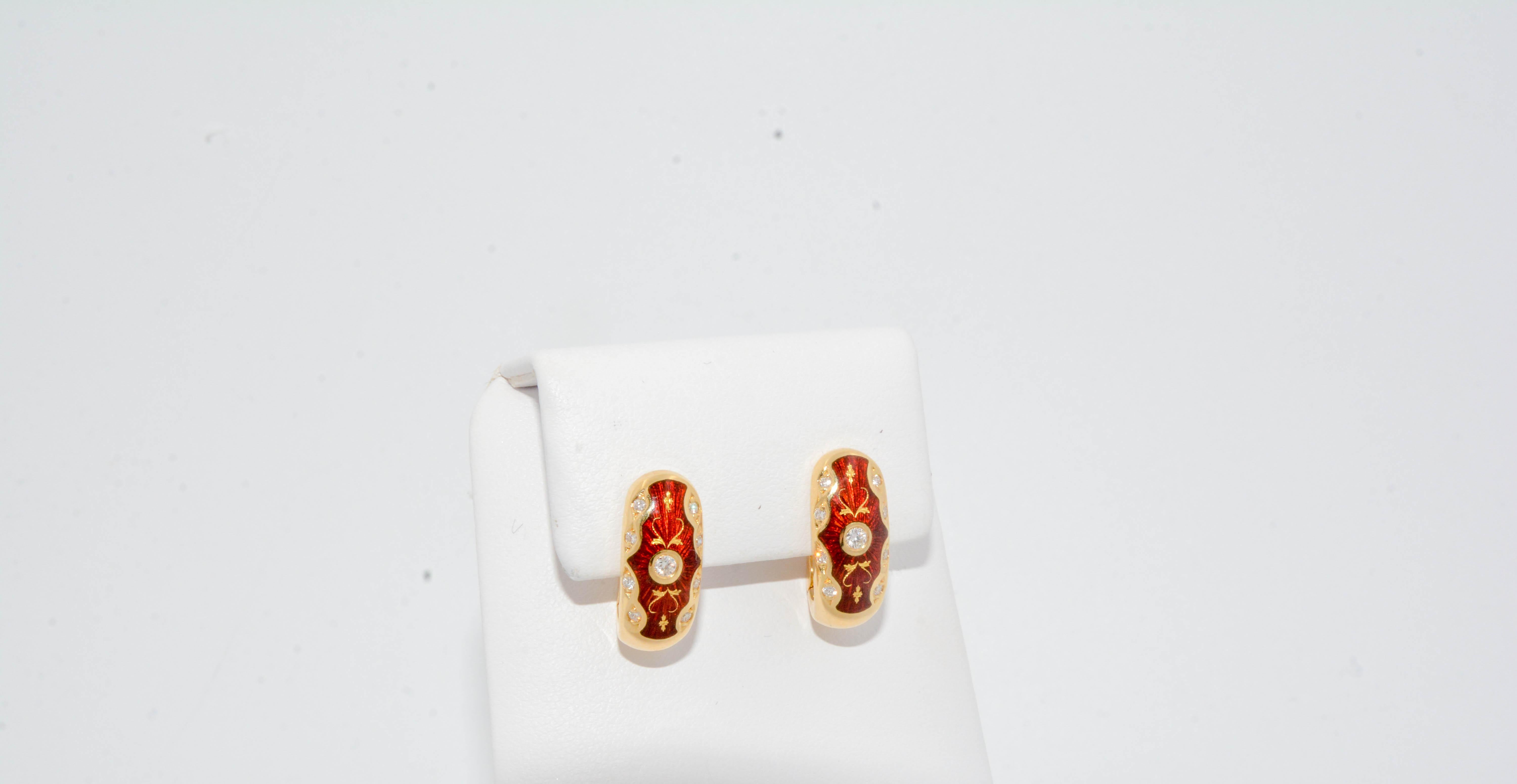 From the court jeweler of the late Czar of Russia- comes a rare masterpiece crafted in perfection from the House of Fabergé . These red enamel huggie hoop earrings are adorned with a delicate gold design with 18 round brilliant diamonds at 0.32ctw