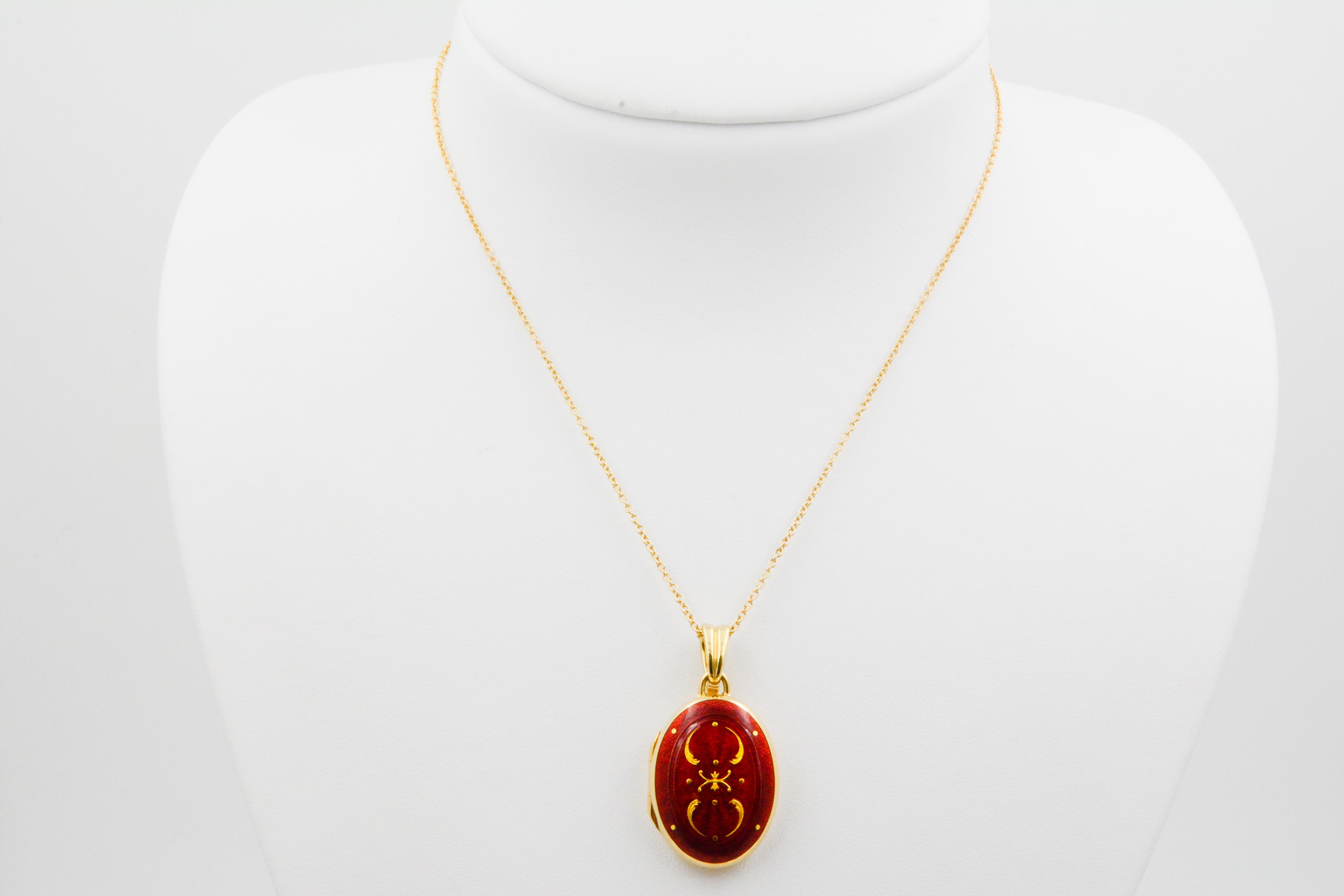 From the court jeweler of the late Czar of Russia- comes a rare masterpiece crafted in perfection from the House of Fabergé. This red enamel locket is adorned with a delicate gold design and set in 18K yellow gold. The inside of the locket is