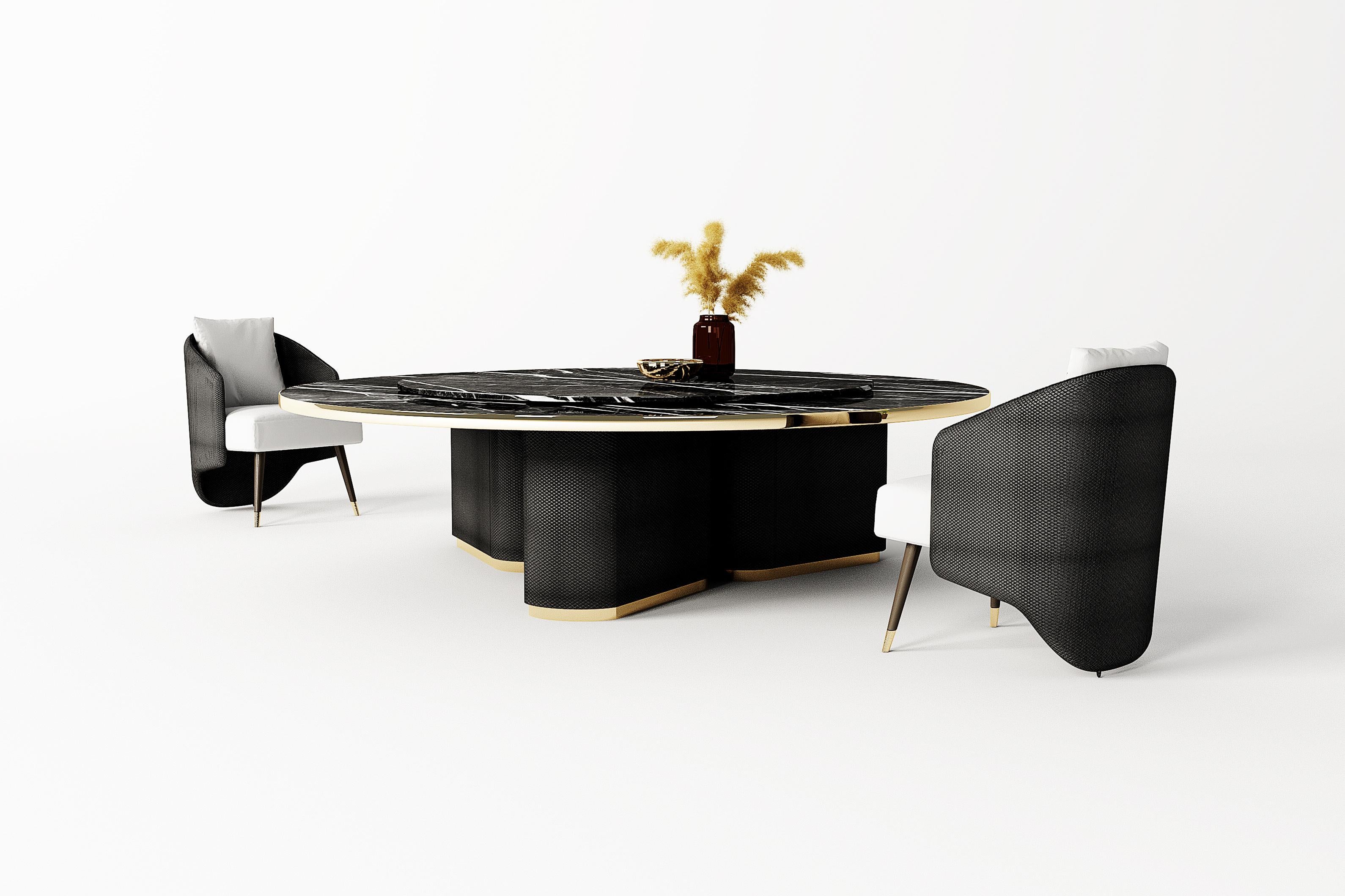 A unique table of significant size with its 280 cm diameter. The three legs covered in black woven leather are supported by a matte gold-finish steel base. The top, detailed lazy susan motion controlled by remote control, makes Fabian a stunning