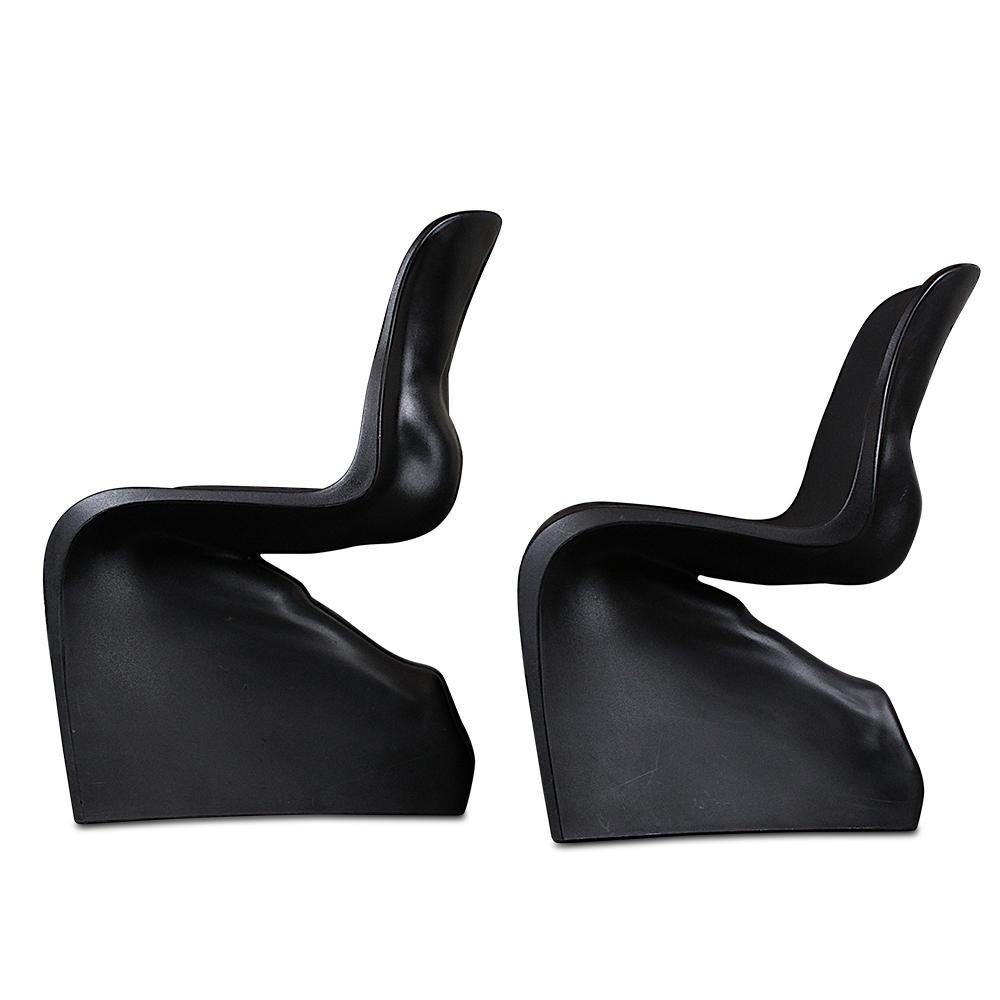 A pair of 'Him' chairs by Fabio Novembre. The cantilevered design takes its cue from Danish designer Verner Panton's iconic Panton chair, with the added playful cheekiness of a back in the form of a naked body. Available for purchase as a pair or