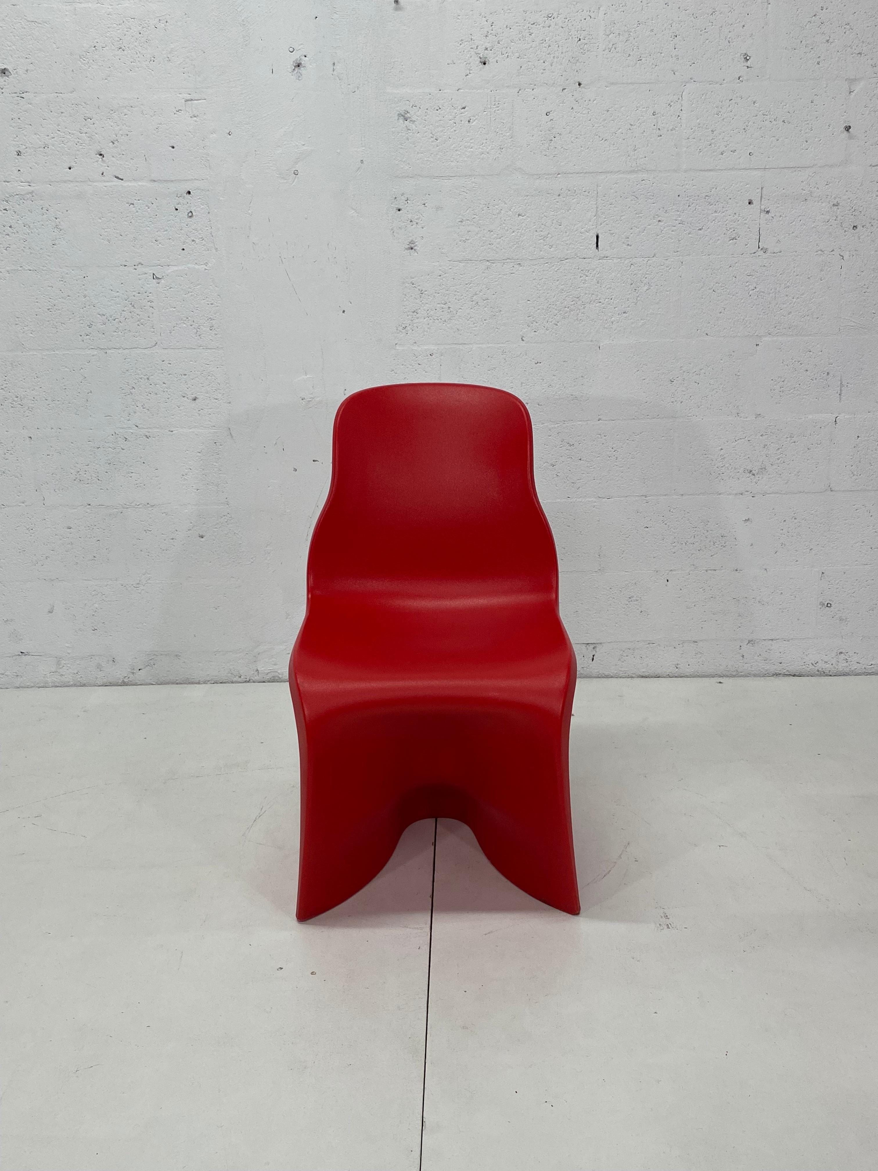 Set of four Her chairs in matte red by Fabio Novembre.

Provocative, playful and sensual, the silhouette of these chairs was created using a three-dimensional scan of a plaster sculpture of a female body. Part of the duo Him & Her chairs designed
