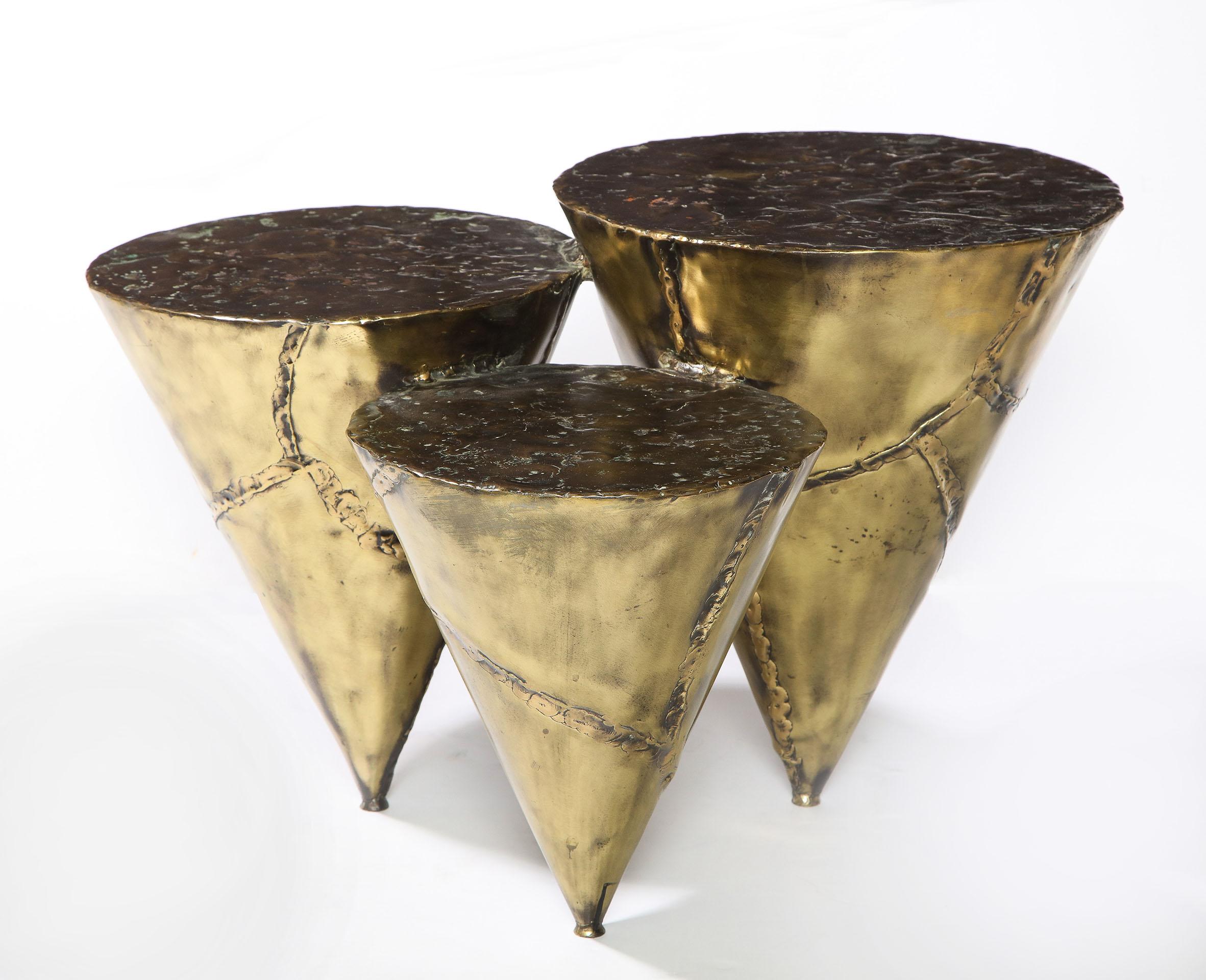 A modular multi-level cone formed coffee table in fabricated brass and bronze. 
Signed: Silas Seandel.