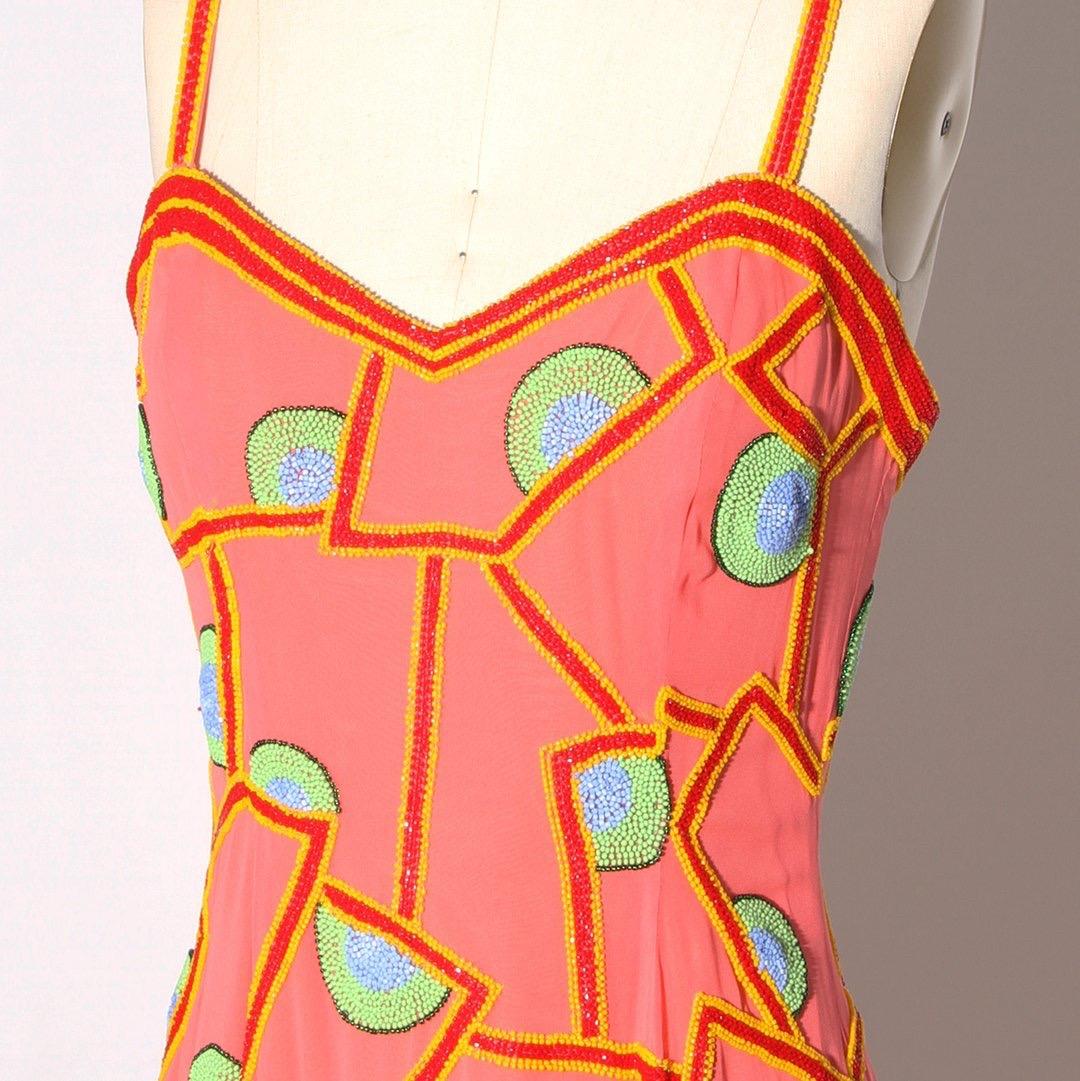 Vintage beaded dress by Fabrice
Peach color
Multicolor beads 
Abstract pattern
Spaghetti straps
Sweetheart neckline
Asymmetrical bottom hem
Back zip with hook and eye closure
Boning in bust to help give support and shape
Condition: Excellent vintage